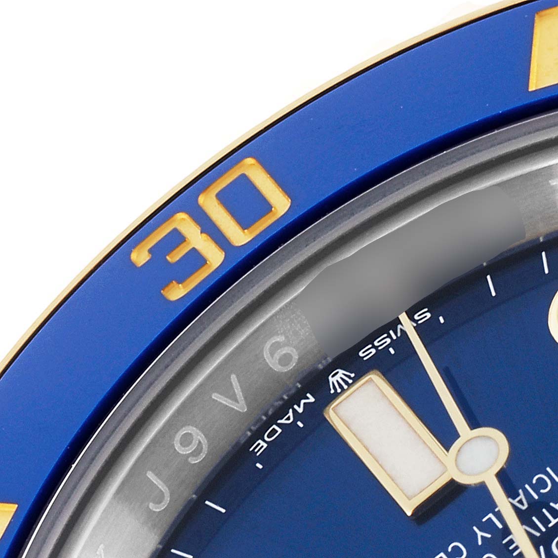 This close-up image of a Rolex Submariner 126613 Men's Steel and Gold (two tone) Blue Dial 126613 Men's Steel and Gold (two tone) Blue Dial watch shows part of the blue bezel and dial, highlighting the "30" marker and "Swiss Made" text.