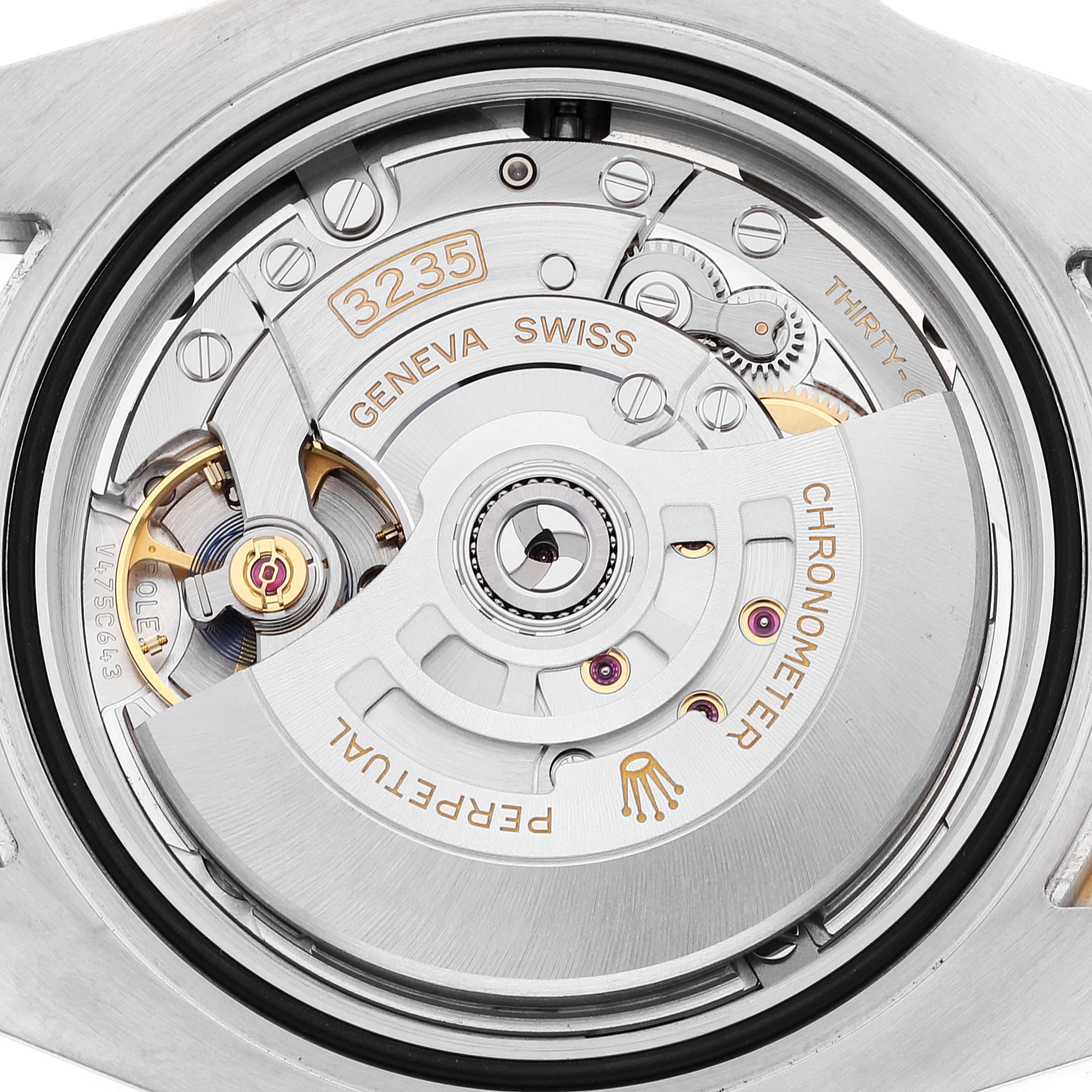 The image shows a close-up of the Rolex Submariner 126613 Men's Steel and Gold (two tone) Blue Dial 126613 Men's Steel and Gold (two tone) Blue Dial's movement, featuring the intricate components of its caliber 3235 mechanism.