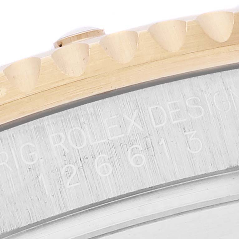 The image shows a close-up of the bezel and the case side of the Rolex Submariner 126613 Men's Steel and Gold (two tone) Blue Dial 126613 Men's Steel and Gold (two tone) Blue Dial.