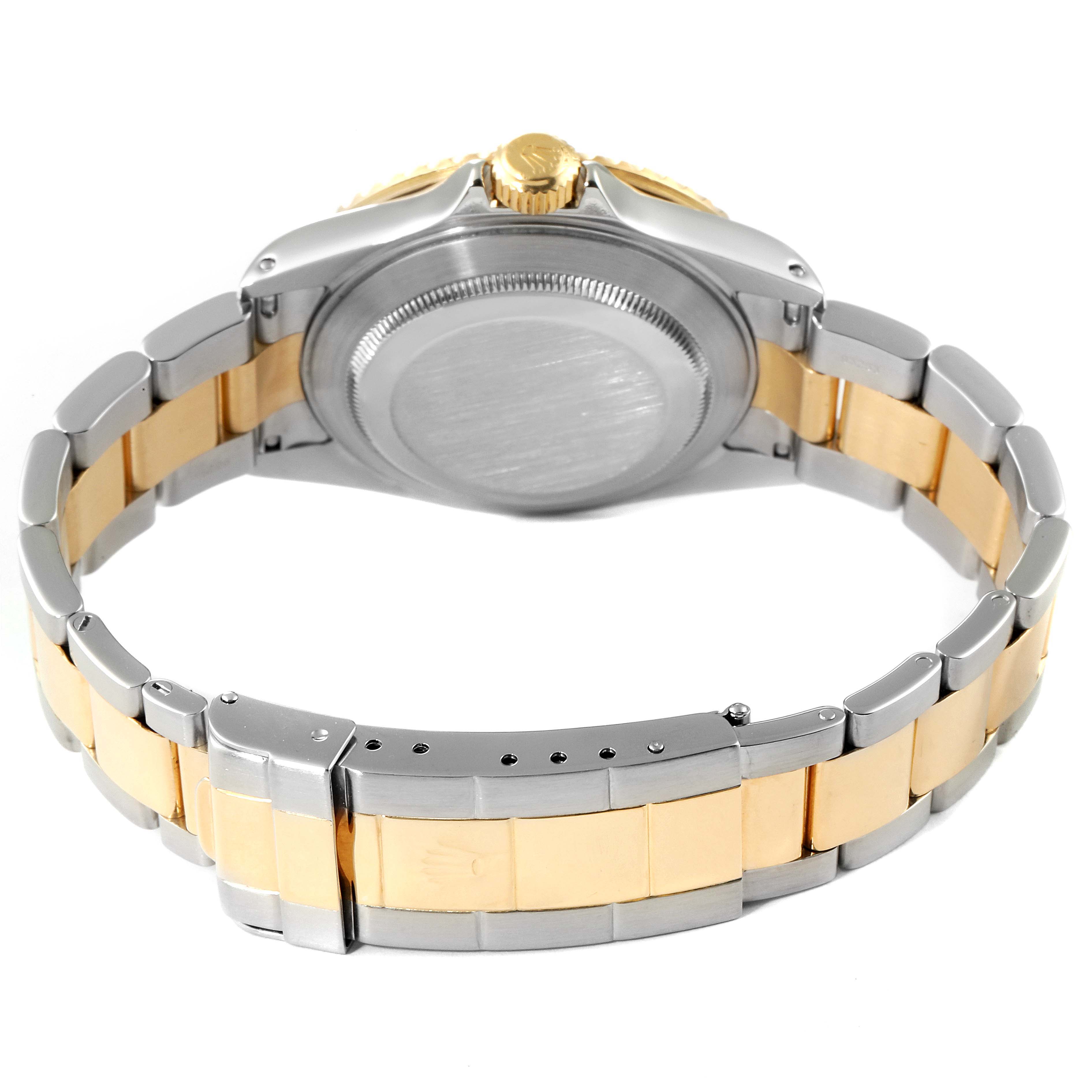 The image shows the back of the Rolex Submariner 16613 Men's Steel and Gold (two tone) Black Dial 16613 Men's Steel and Gold (two tone) Black Dial watch, including the caseback and two-tone bracelet.