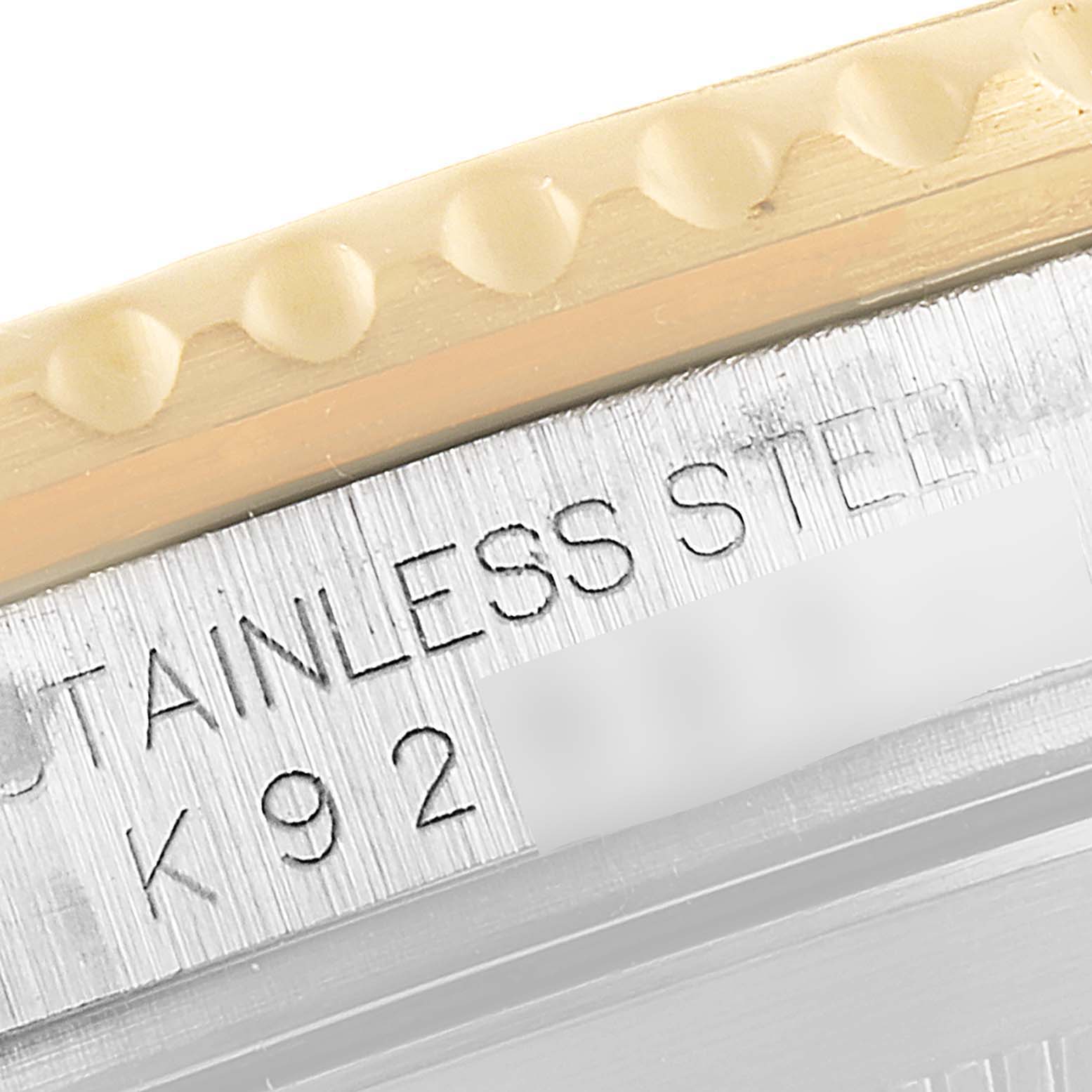 The image shows a close-up of the side of a Rolex Submariner 16613 Men's Steel and Gold (two tone) Black Dial 16613 Men's Steel and Gold (two tone) Black Dial watch, highlighting the stainless steel and part of the bezel.