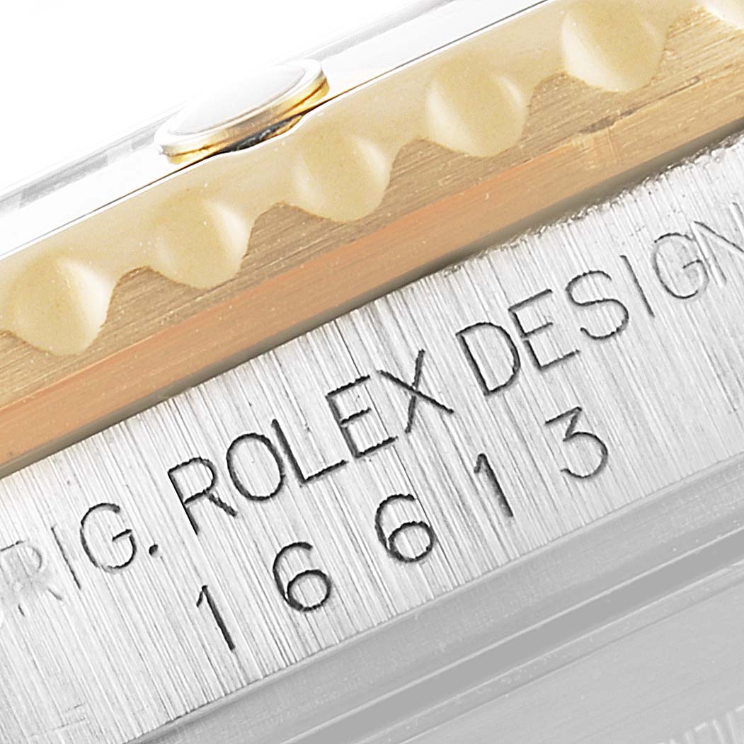 Close-up of the side engraving showing "ROLEX DESIGN 16613" on the Rolex Submariner 16613 Men's Steel and Gold (two tone) Black Dial 16613 Men's Steel and Gold (two tone) Black Dial's case.