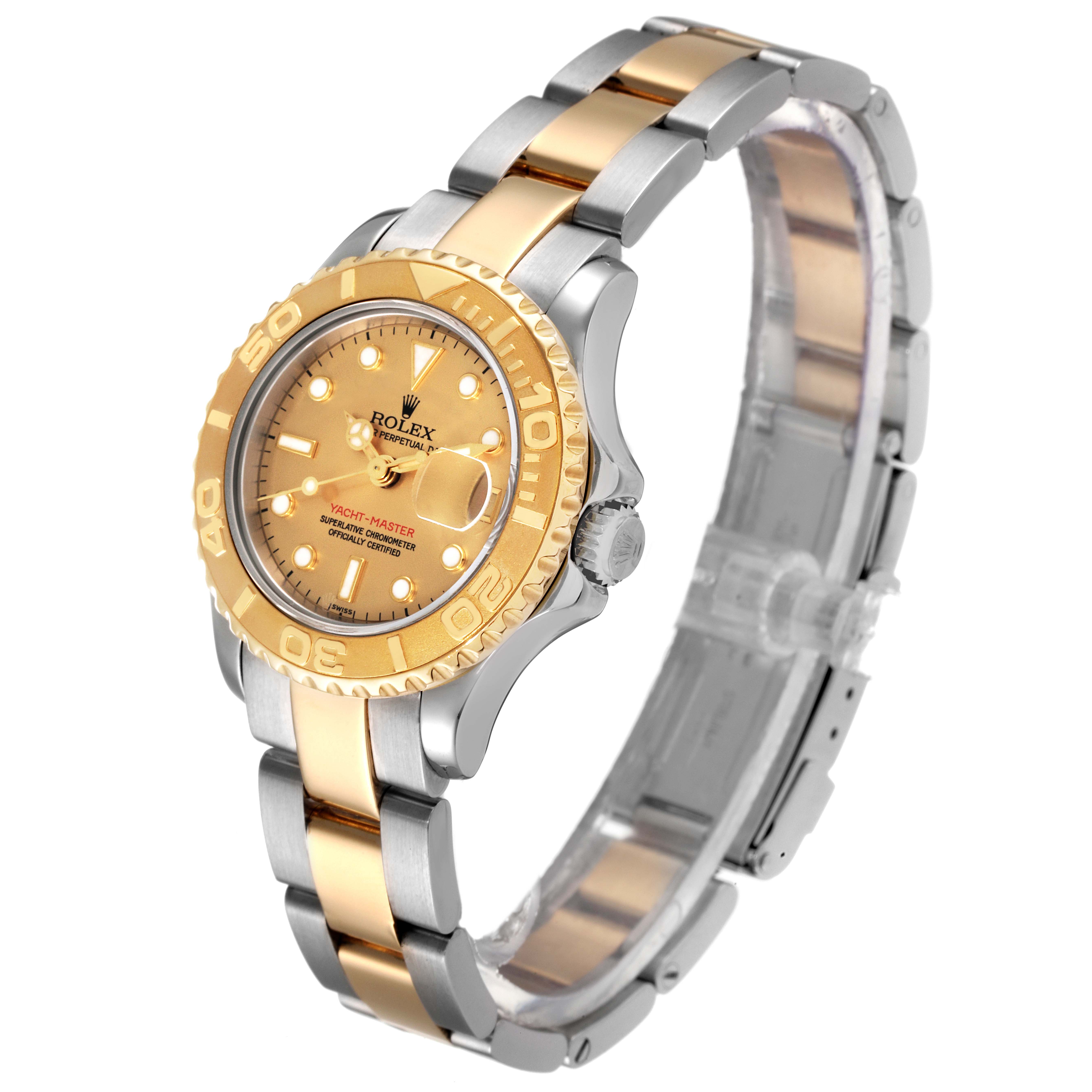 The image shows a side and front angle of a Rolex Yacht-Master 69623 Women's Steel and Gold (two tone) Champagne Dial 69623 Women's Steel and Gold (two tone) Champagne Dial watch with a two-tone gold and silver bracelet.