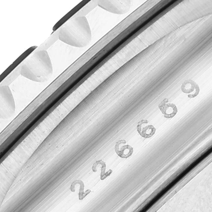 This close-up image shows the side view of the Rolex Yacht-Master 226659 Men
s White Gold Black Dial 226659 Men
s White Gold Black Dial watch, highlighting its bezel and engraved numbers.