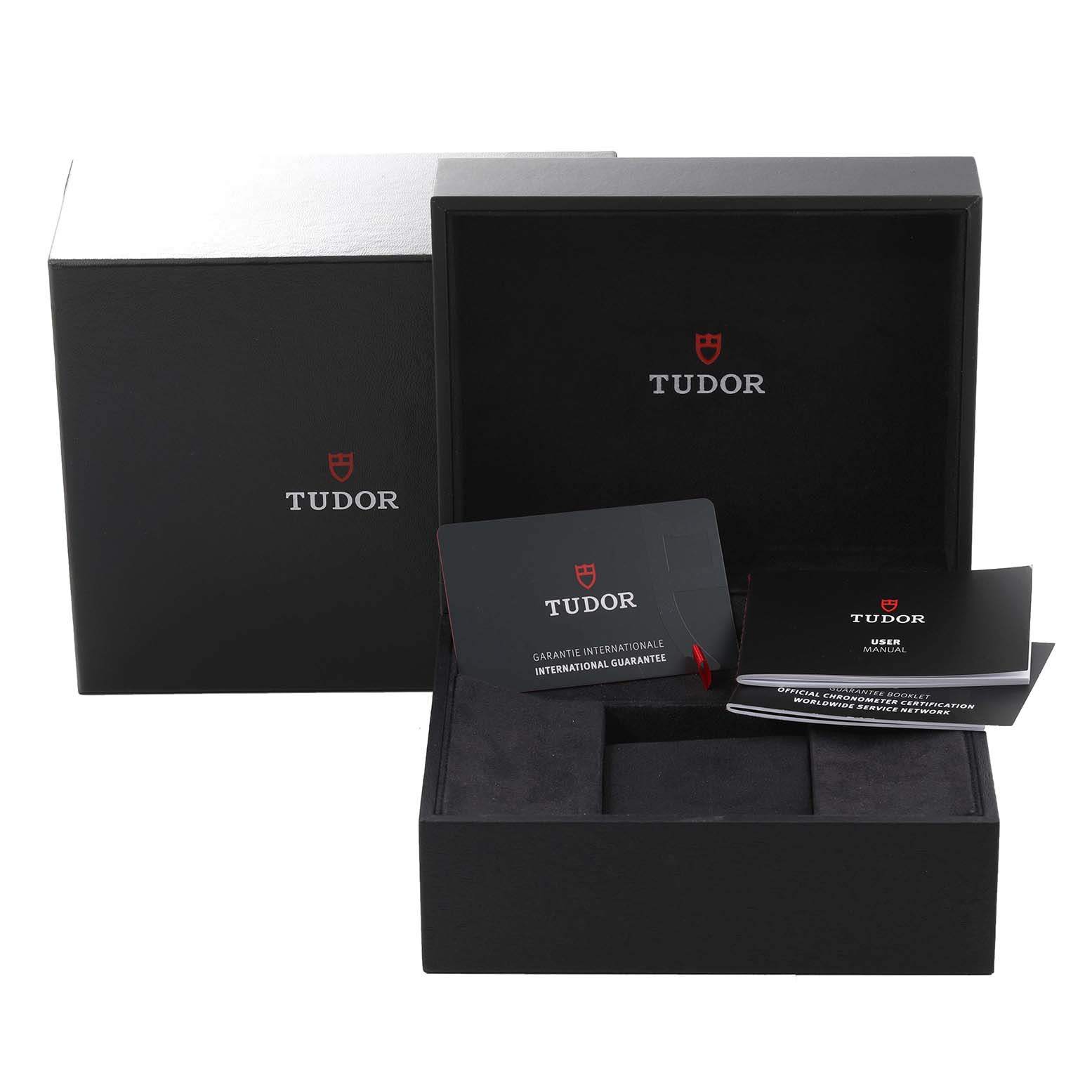 The image shows the packaging and documentation for the Tudor Heritage Black Bay M79030N-0001 Men's Stainless Steel Black Dial M79030N-0001 Men's Stainless Steel Black Dial watch, including the box, international guarantee card, and user manual.