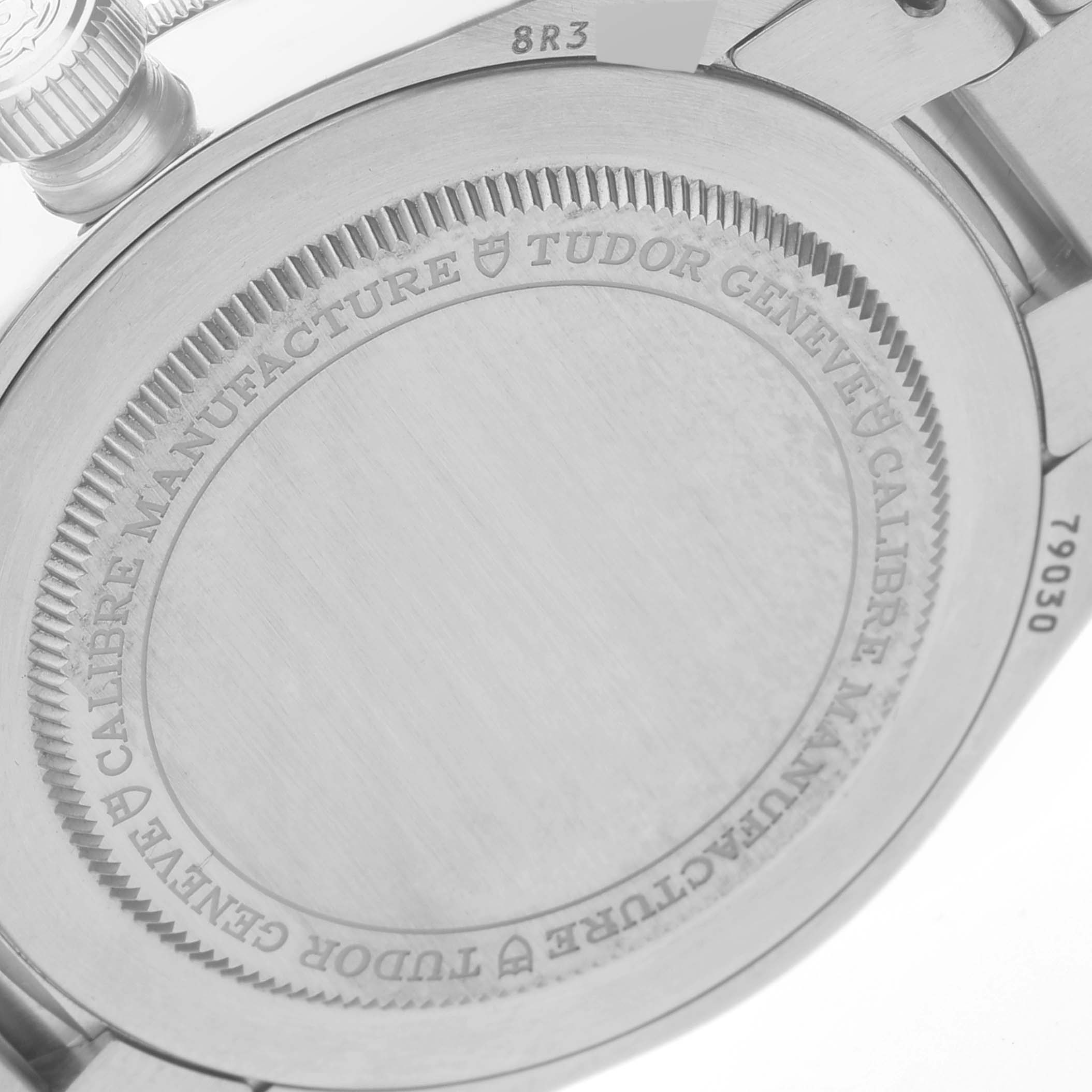 The image shows the case back of the Tudor Heritage Black Bay M79030N-0001 Men's Stainless Steel Black Dial M79030N-0001 Men's Stainless Steel Black Dial watch, displaying its engraved text and serial numbers.