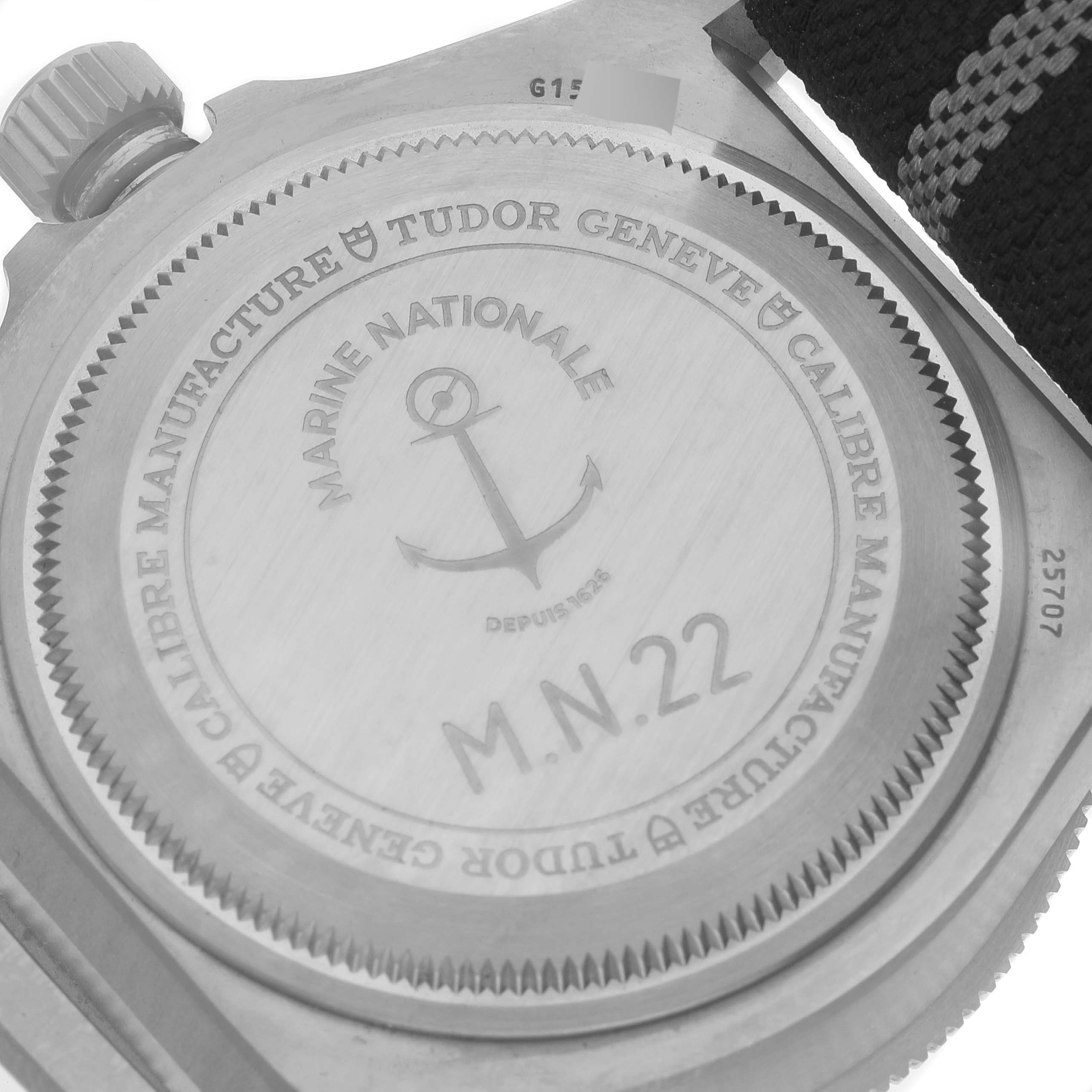 The image shows the case back of a Tudor Pelagos 25707 Men's Titanium Blue Dial 25707 Men's Titanium Blue Dial watch, highlighting its engraving details and crown.