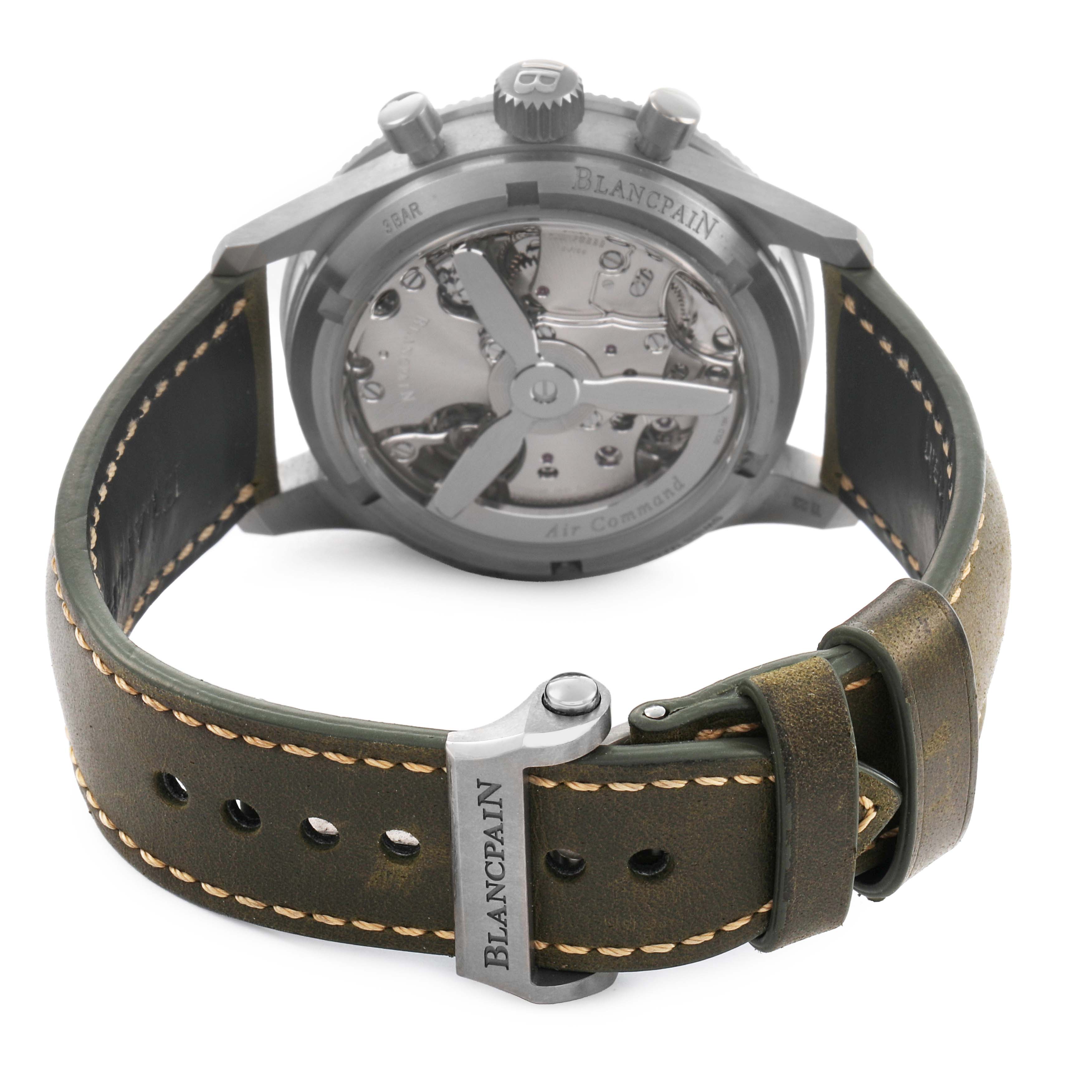 The Blancpain Air Command AC02 12B53 63B Men's Titanium Green Dial watch is shown from the back, highlighting the open case back and leather strap with stitching.