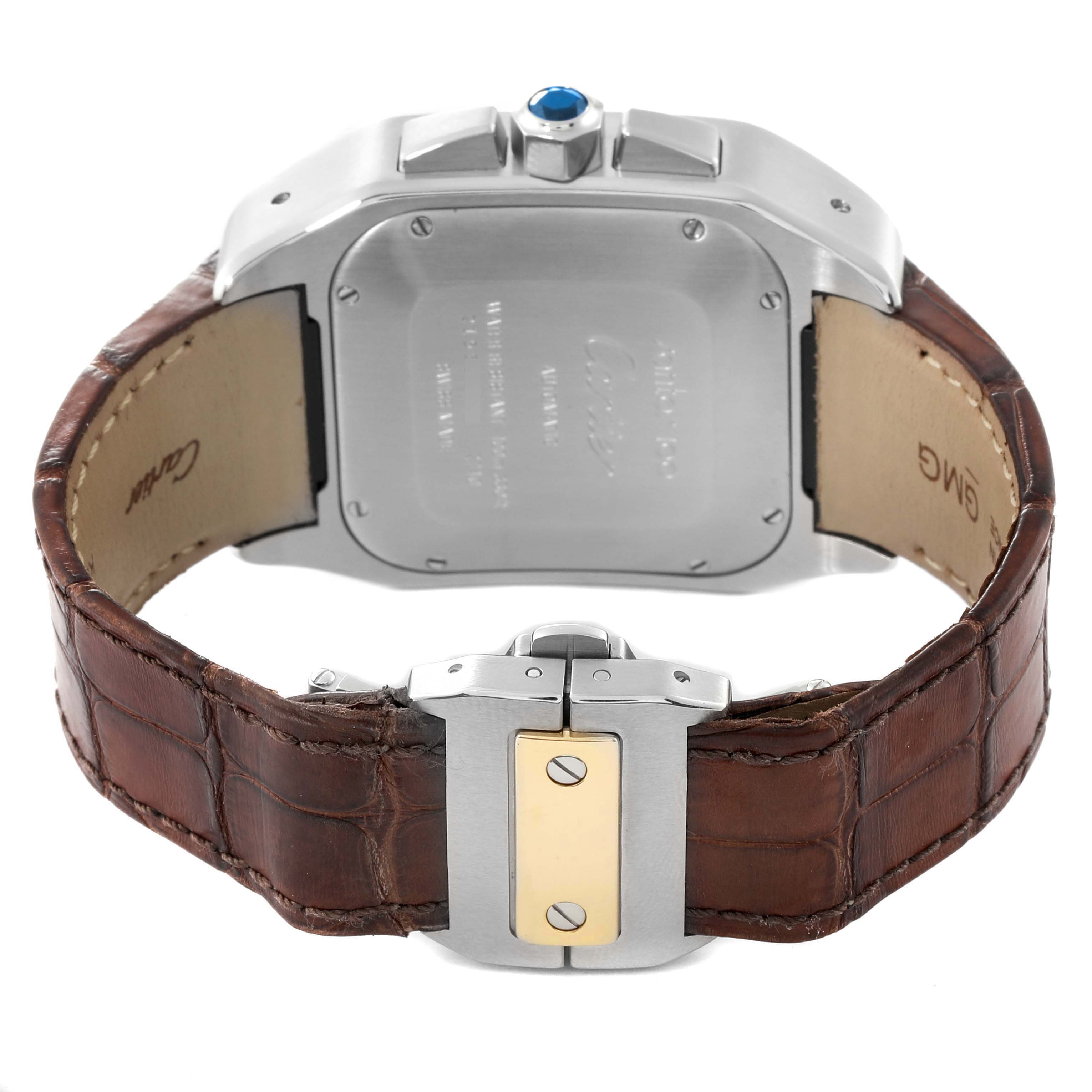 The image shows the backside of the Cartier Santos W20091X7 Men's Steel and Gold (two tone) Silver Dial W20091X7 Men's Steel and Gold (two tone) Silver Dial watch, highlighting the clasp, case back, and brown leather strap.