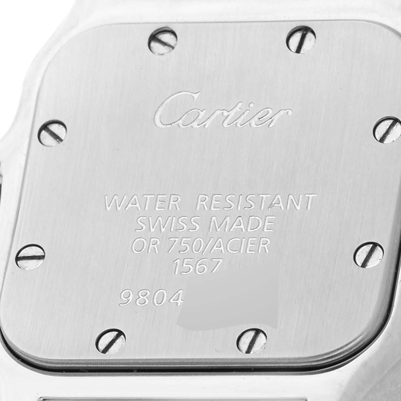 The image shows the case back of a Santos model by Cartier, revealing the brand's engraving and specifications.