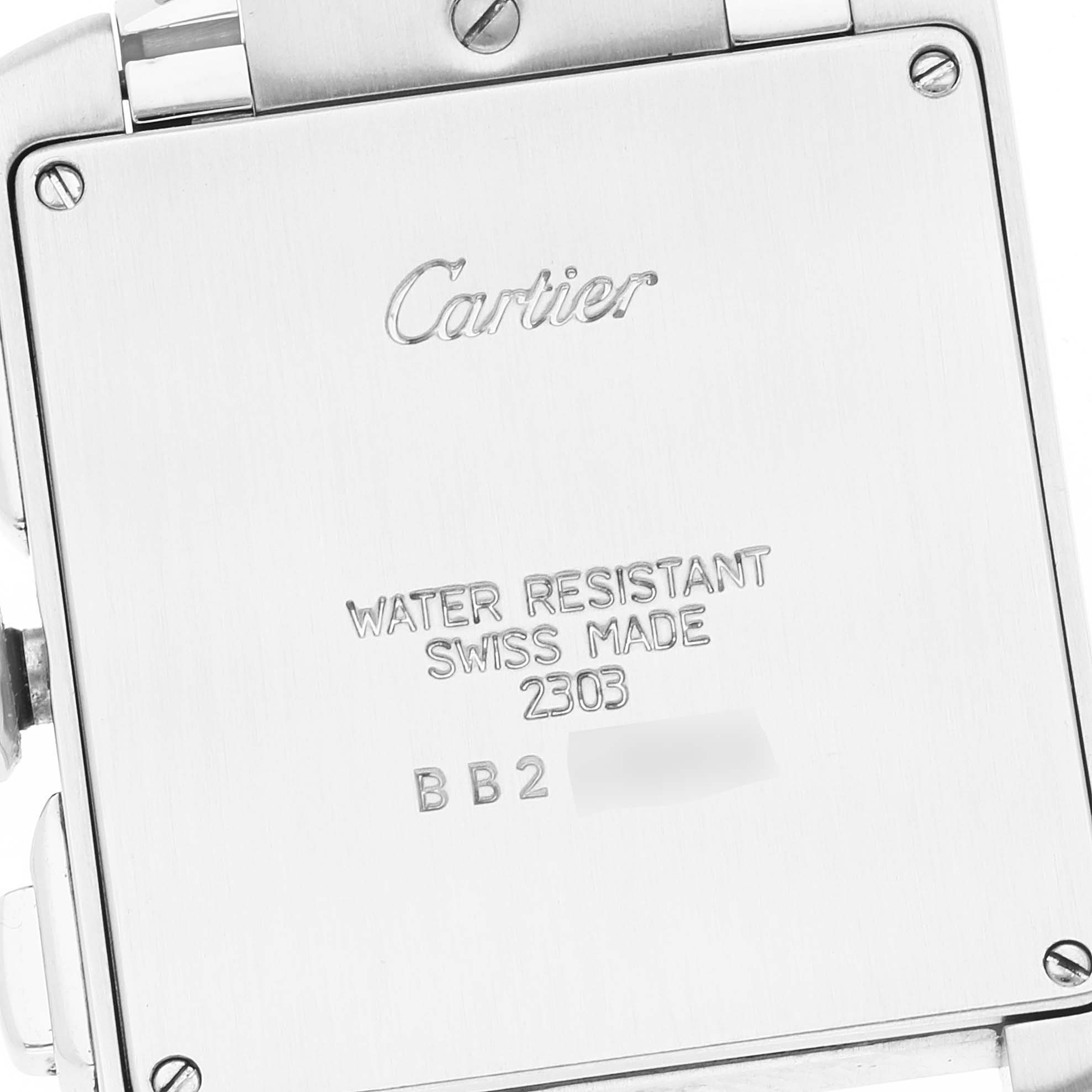 This is a close-up view of the back of a Cartier Tank Francaise W51001Q3 Men
s Stainless Steel Silver Dial W51001Q3 Men
s Stainless Steel Silver Dial watch, showing its engravings and screws.