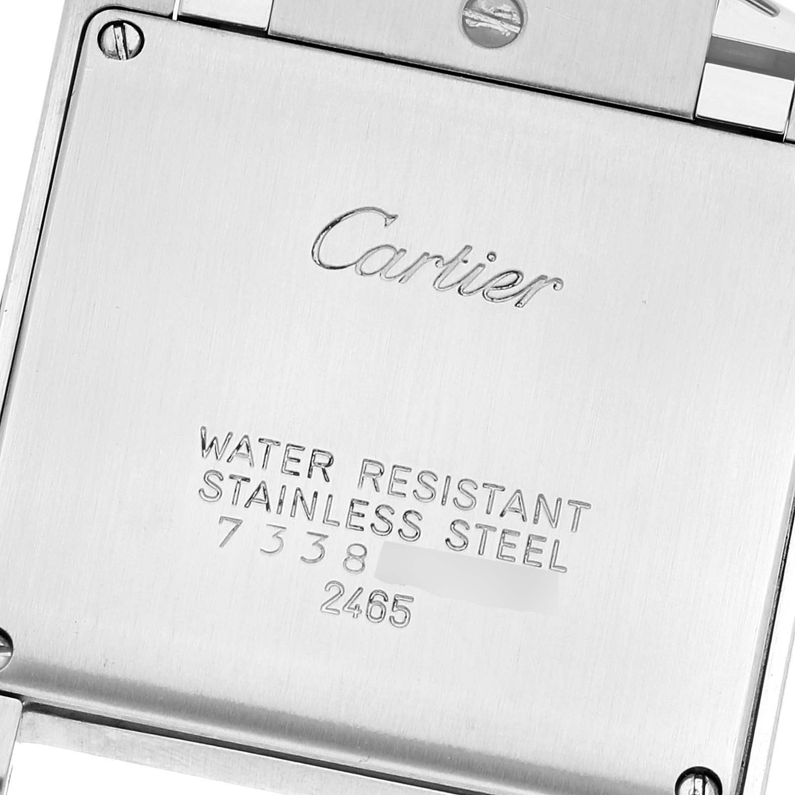 This image shows the back case of a Cartier Tank Française watch, highlighting its engravings and screws.