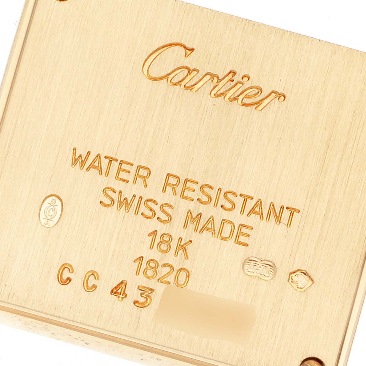 The image shows the back plate of a Cartier Tank Francaise W5000256 Women
s Yellow Gold Silver Dial W5000256 Women
s Yellow Gold Silver Dial watch, detailing its water resistance, 18K gold composition, and Swiss origin.