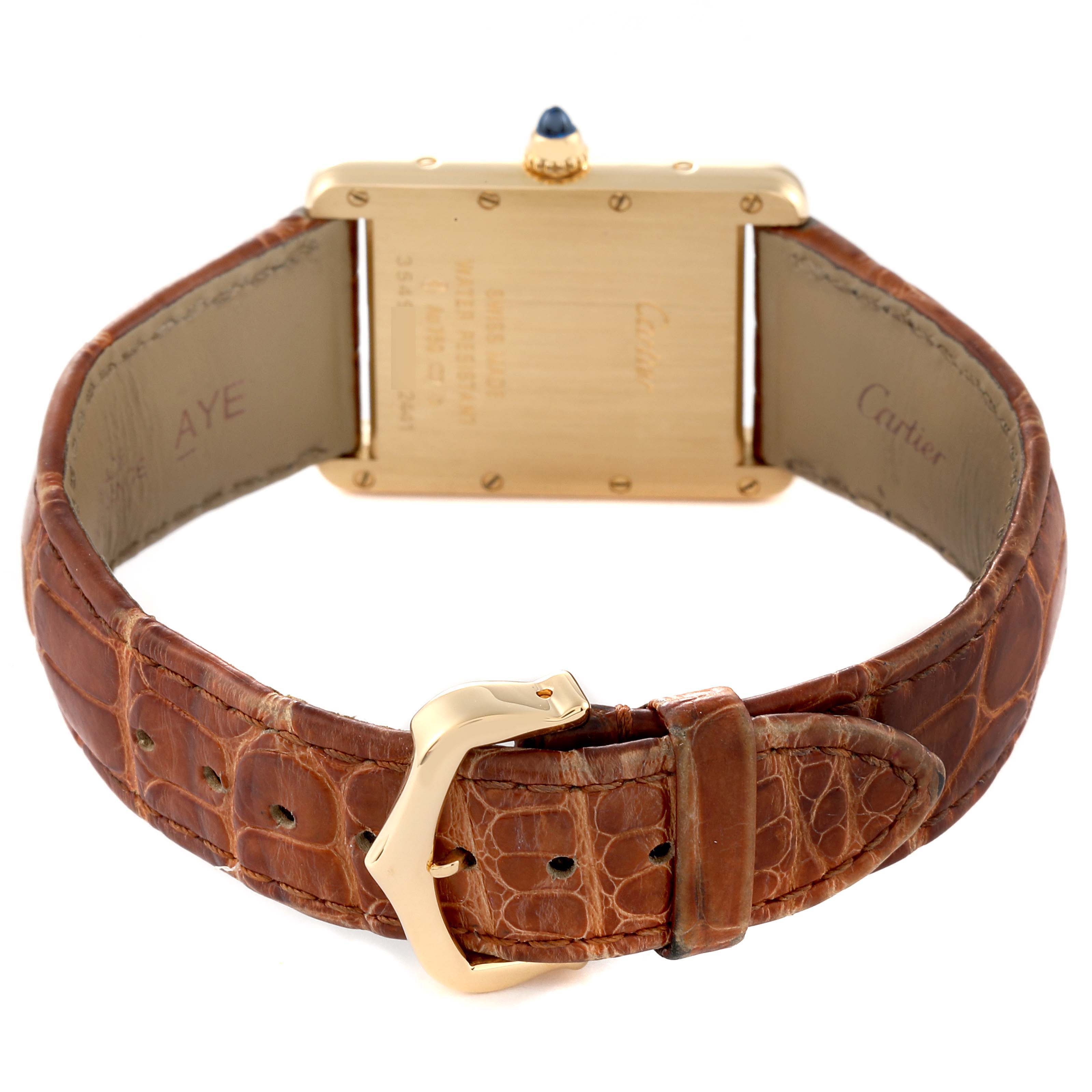 This image shows the back case and brown leather strap of the Tank Louis Cartier watch.