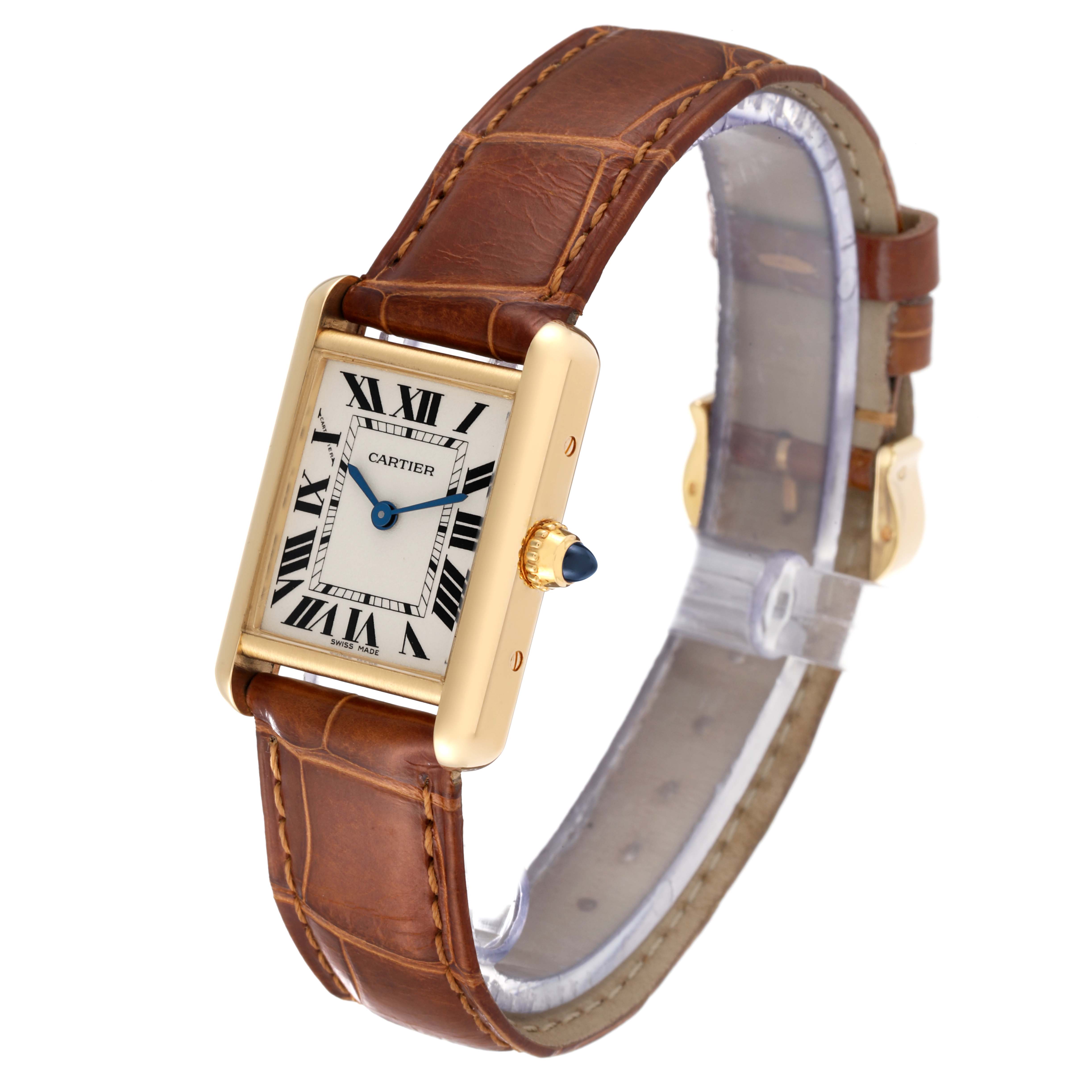 The image shows a Tank Louis watch by Cartier at an angle highlighting the face, crown, and brown leather strap.