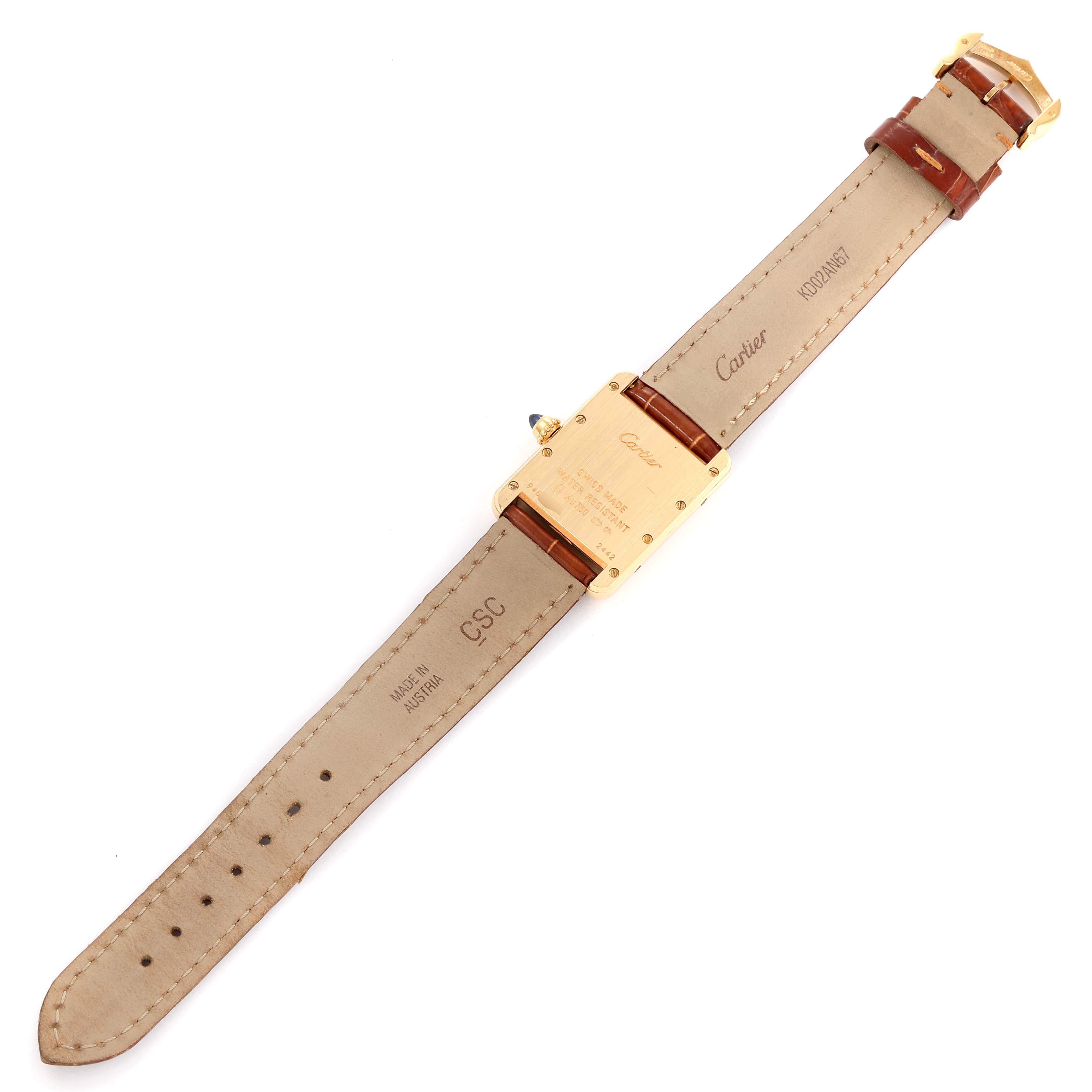 The image shows the back view of a Tank Louis model by Cartier, highlighting the leather strap and case back with engravings.