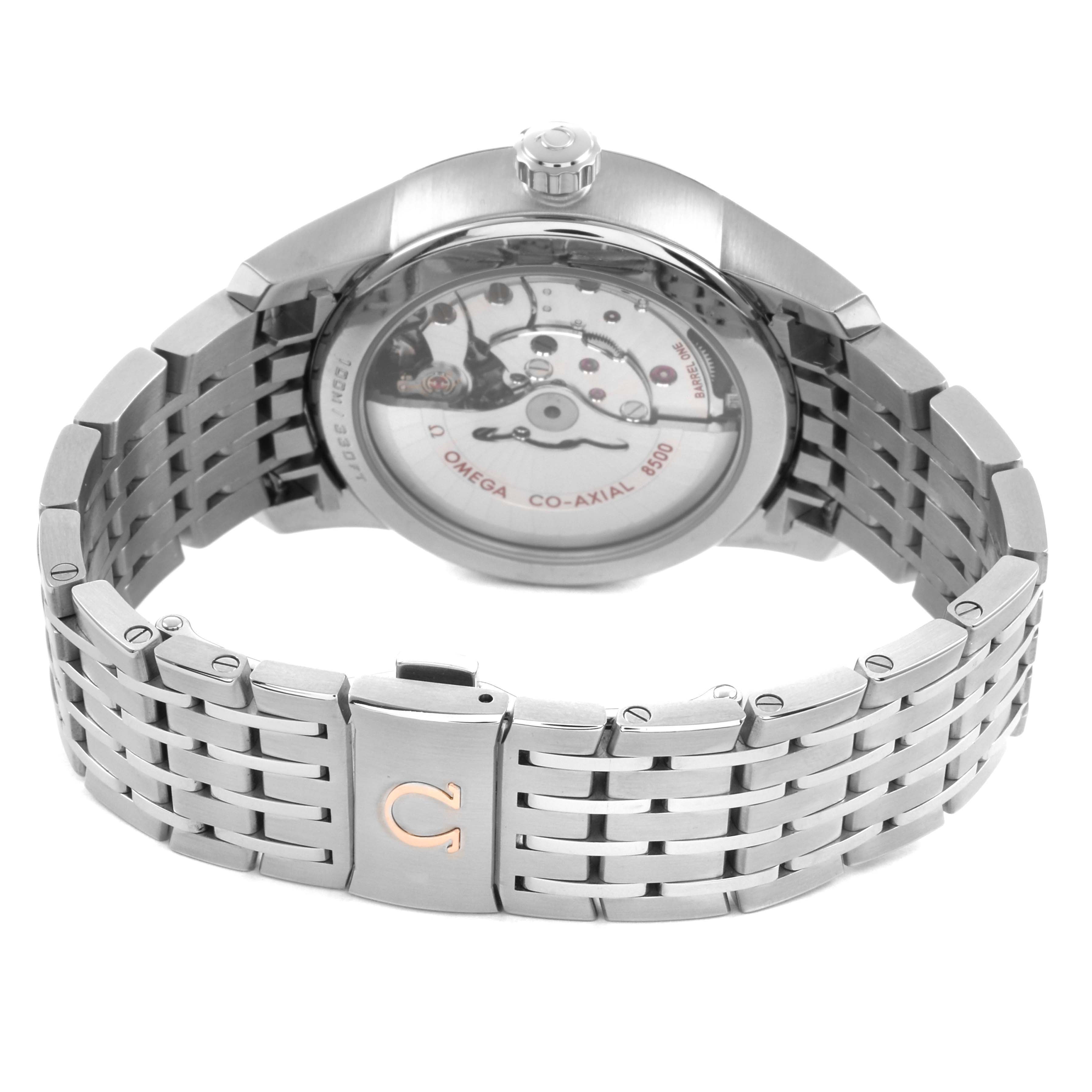The Omega De Ville 433.10.41.21.02.001 Men's Stainless Steel Silver Dial watch is shown from the back, displaying the case back, movement, crown, and part of the metal bracelet.