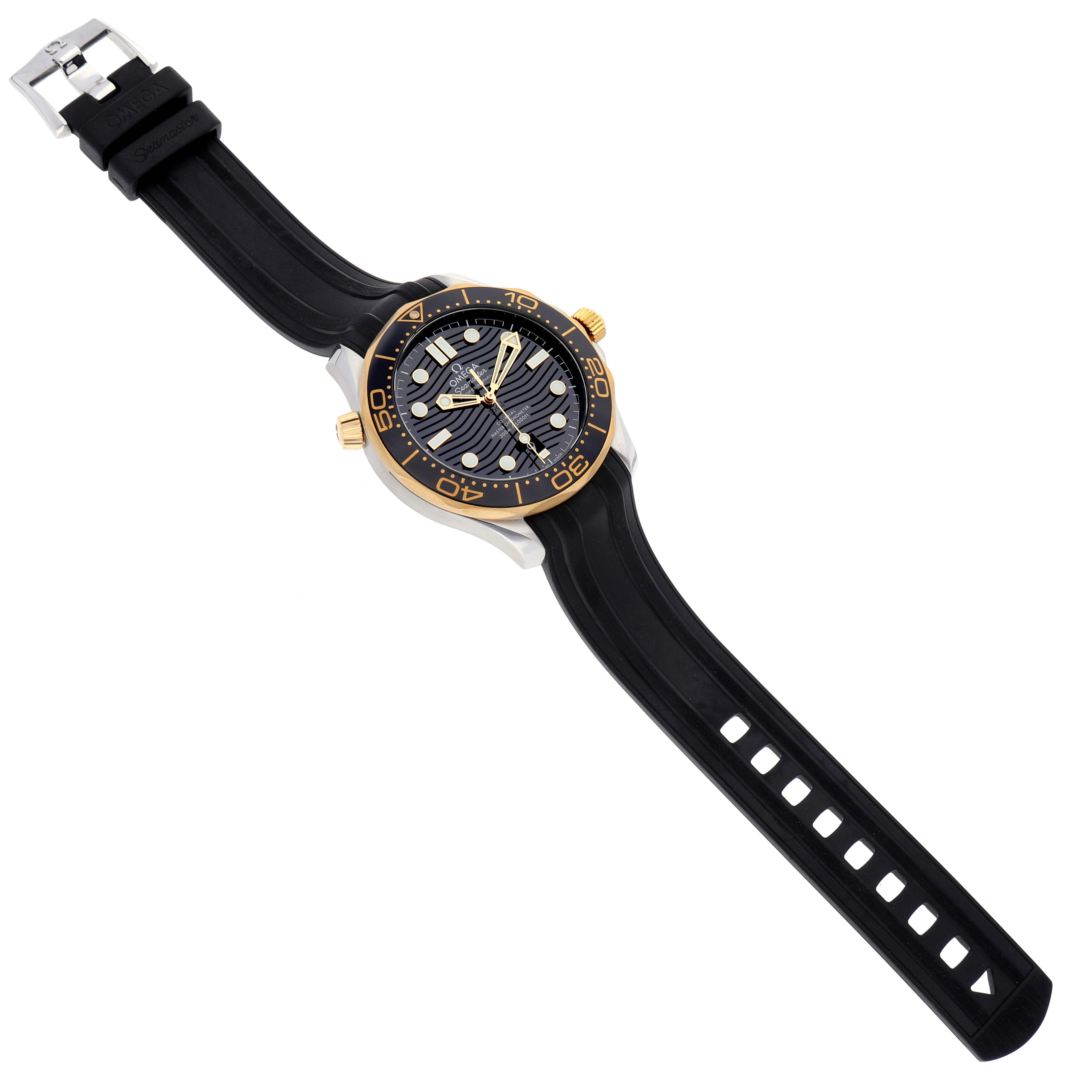 The Omega Seamaster 210.22.42.20.01.001 Men's Steel and Gold (two tone) Black Dial 210.22.42.20.01.001 Men's Steel and Gold (two tone) Black Dial watch is shown at an angle showcasing its black embossed dial, gold bezel, and black strap with a silver buckle.