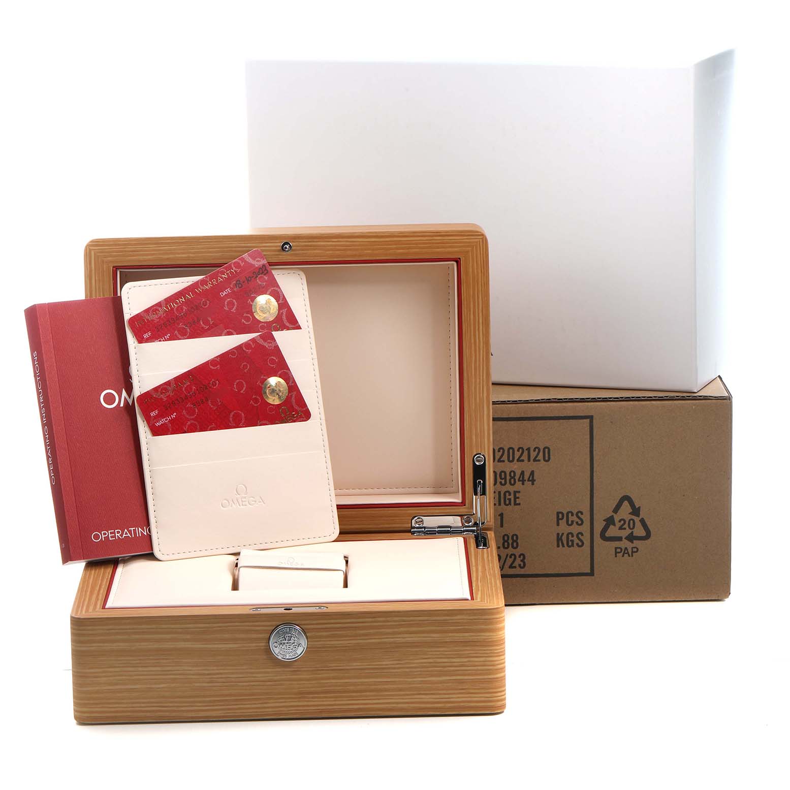 The image shows an Omega Speedmaster 329.33.43.51.02.001 Men's Stainless Steel Silver Dial watch box, open with documents and cards, viewed from a front angle.