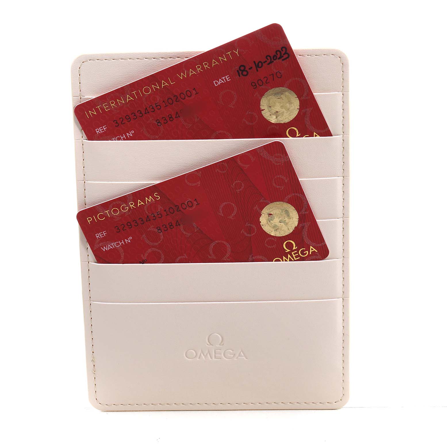 The image shows Omega Speedmaster 329.33.43.51.02.001 Men's Stainless Steel Silver Dial model warranty and pictogram cards in a cream card holder.