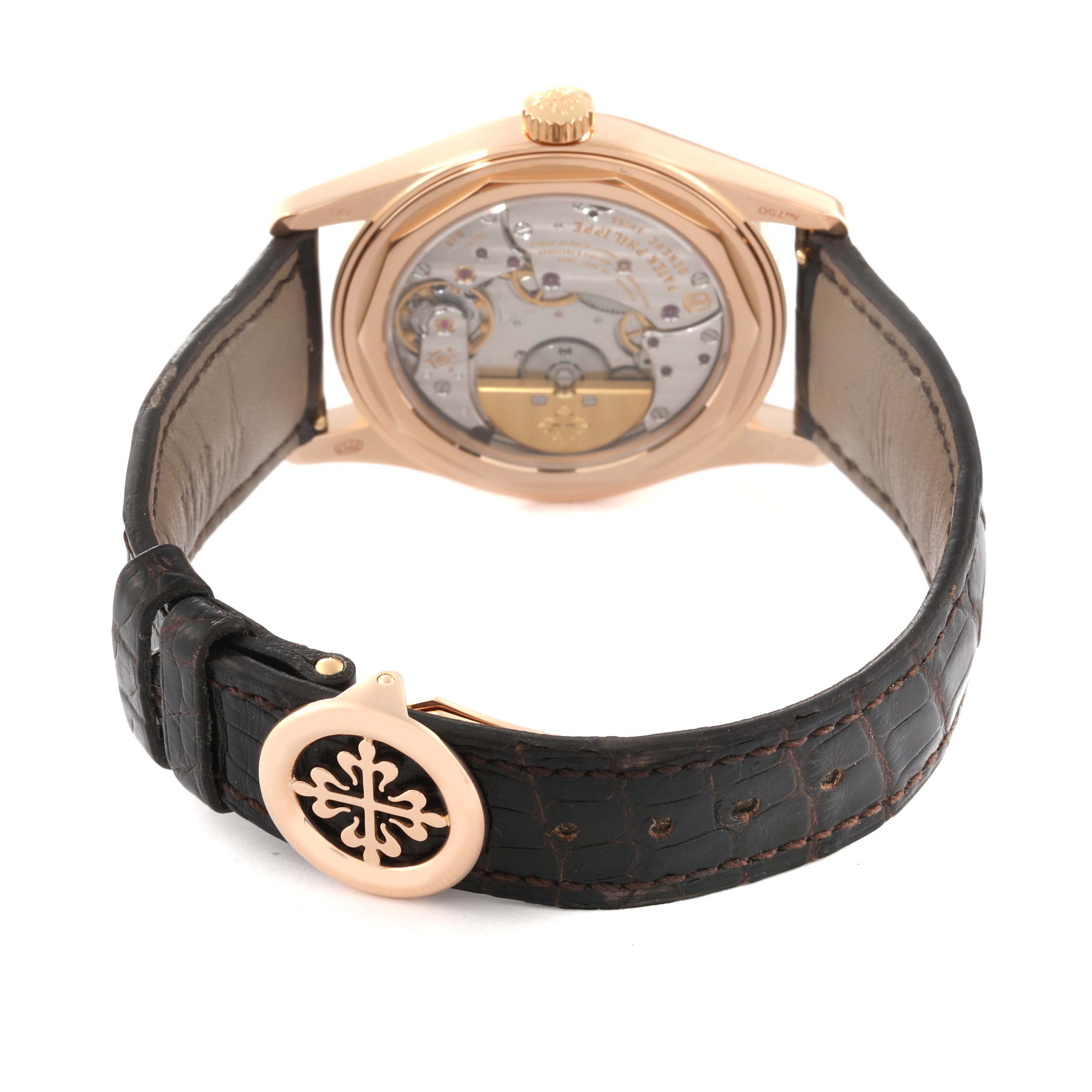 The image shows the back view of the Patek Philippe Calatrava 6000R-001 Men's Rose Gold Brown Dial 6000R-001 Men's Rose Gold Brown Dial watch, highlighting its movement mechanism and leather strap.