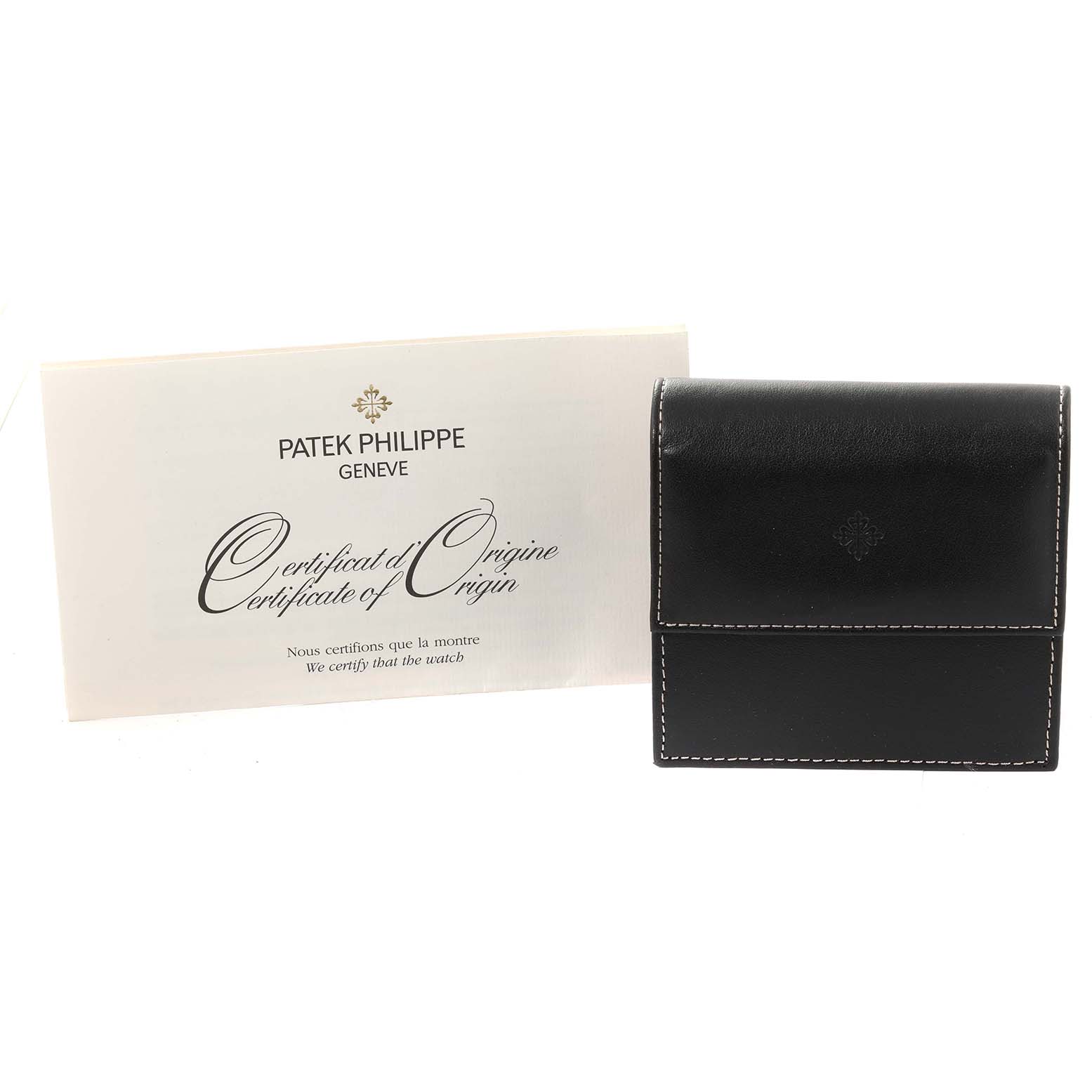 The image shows a Patek Philippe Certificate of Origin and a black leather case for the Calatrava model.