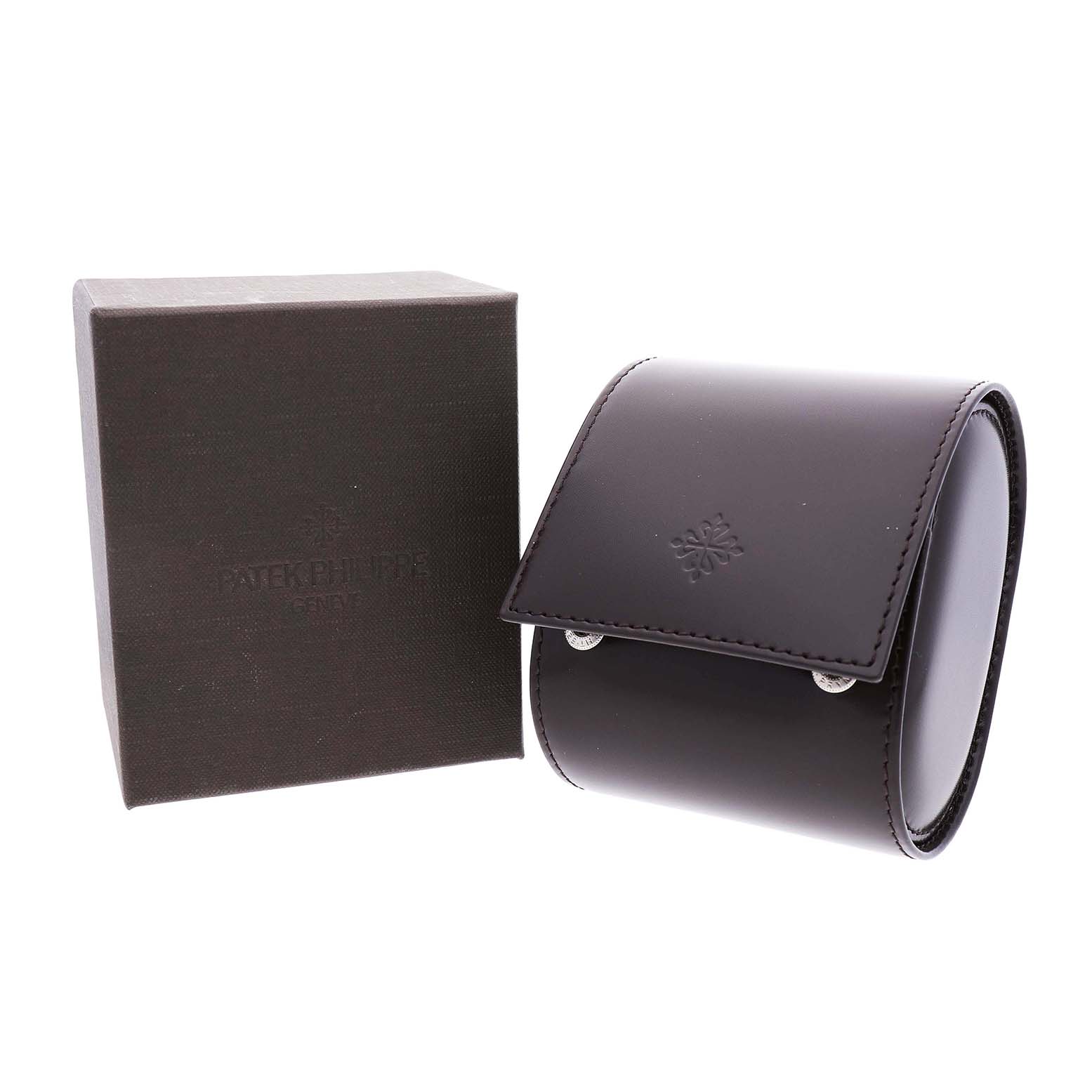 The image shows a Patek Philippe Twenty-4 4910/10A Women's Stainless Steel Black Dial model's packaging, featuring a box and a leather watch case.