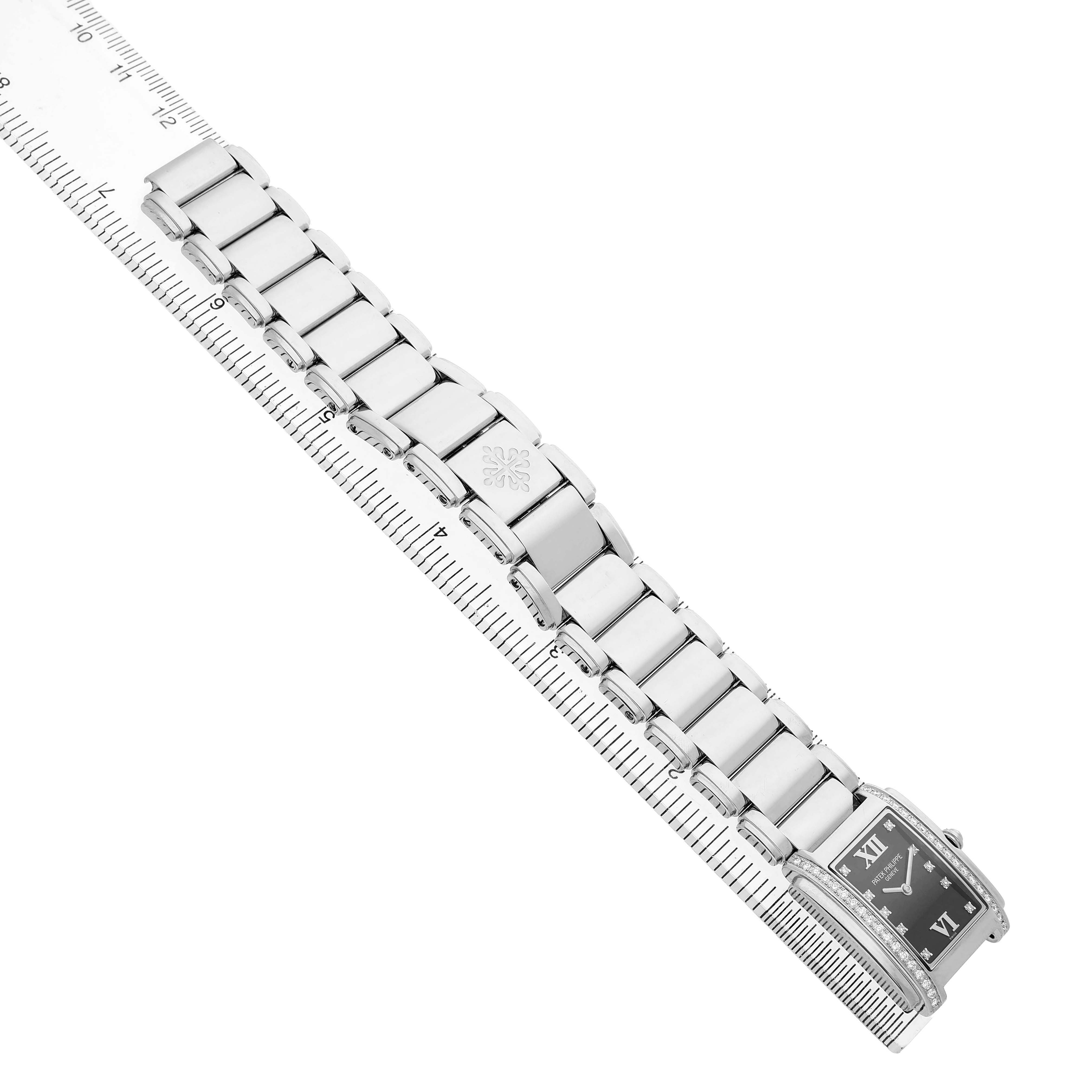 The Patek Philippe Twenty-4 4910/10A Women's Stainless Steel Black Dial watch is shown at a diagonal angle, highlighting the bracelet and part of the rectangular dial.