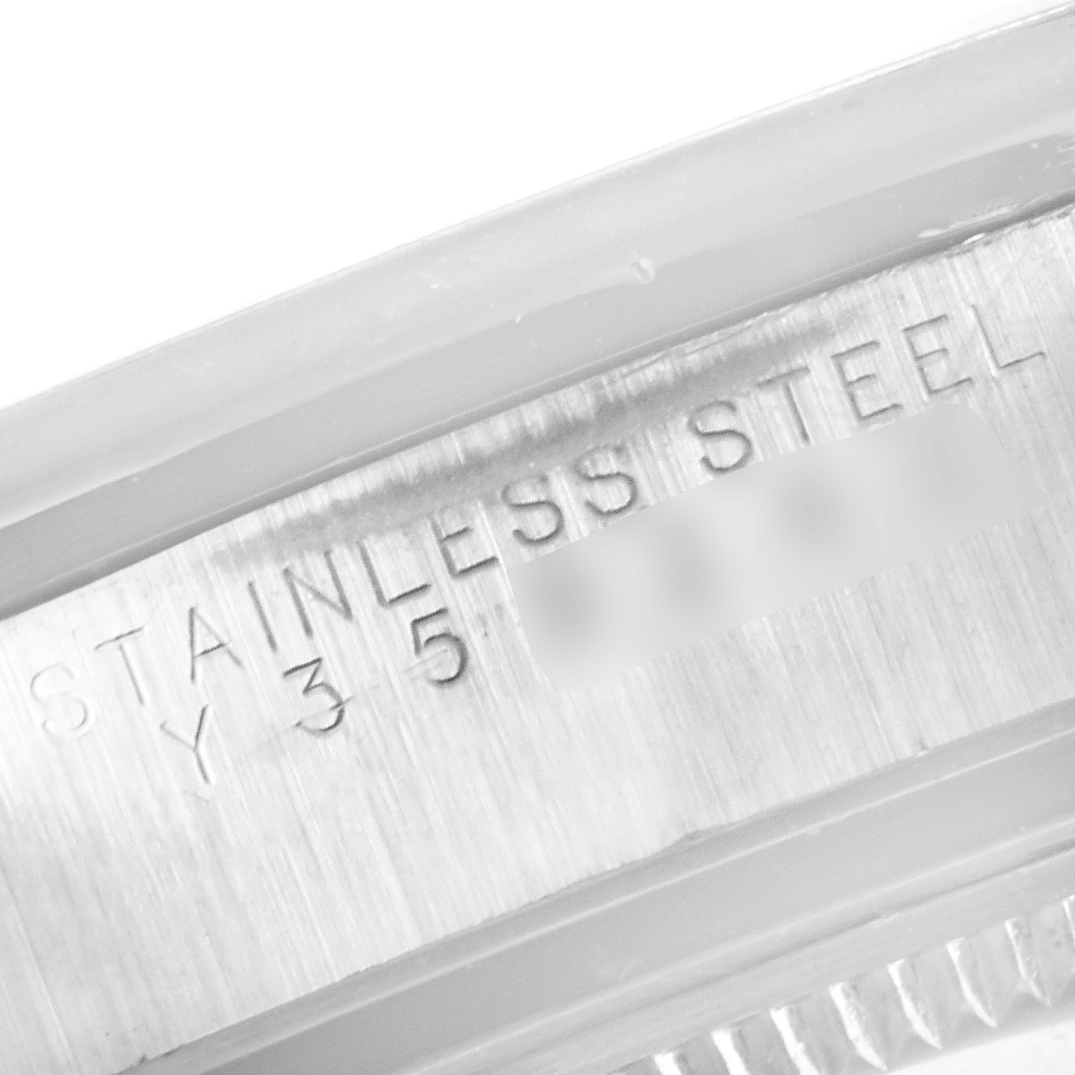 This image shows a close-up angle of the model and serial number engraving on the stainless steel case of a Rolex Air-King 14000 Men's Stainless Steel Black Dial 14000 Men's Stainless Steel Black Dial watch.