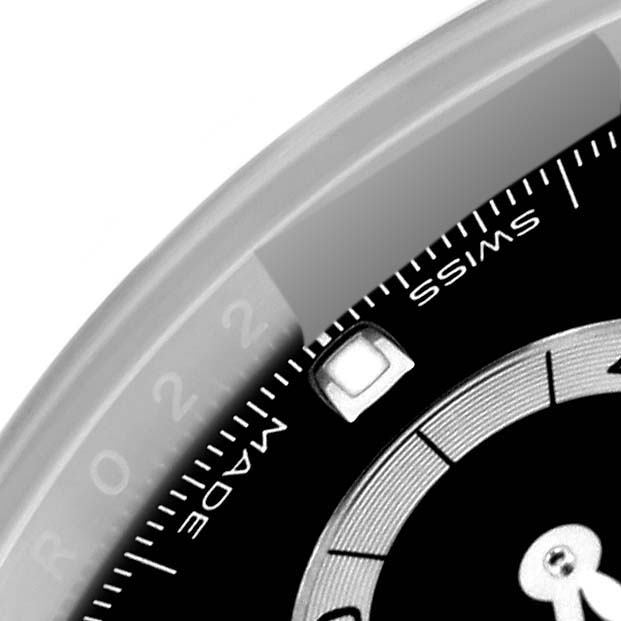 This close-up image of a Rolex Daytona 116500 Men's Stainless Steel Black Dial 116500 Men's Stainless Steel Black Dial watch shows the edge of the dial with "SWISS" and "MADE" text, along with the bezel.