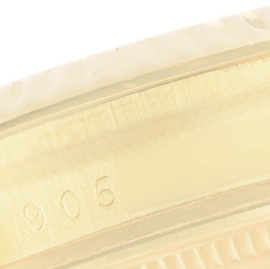 This is a close-up image of the side of a Vintage Collection Rolex watch, showing part of the casing and a serial number engraving.