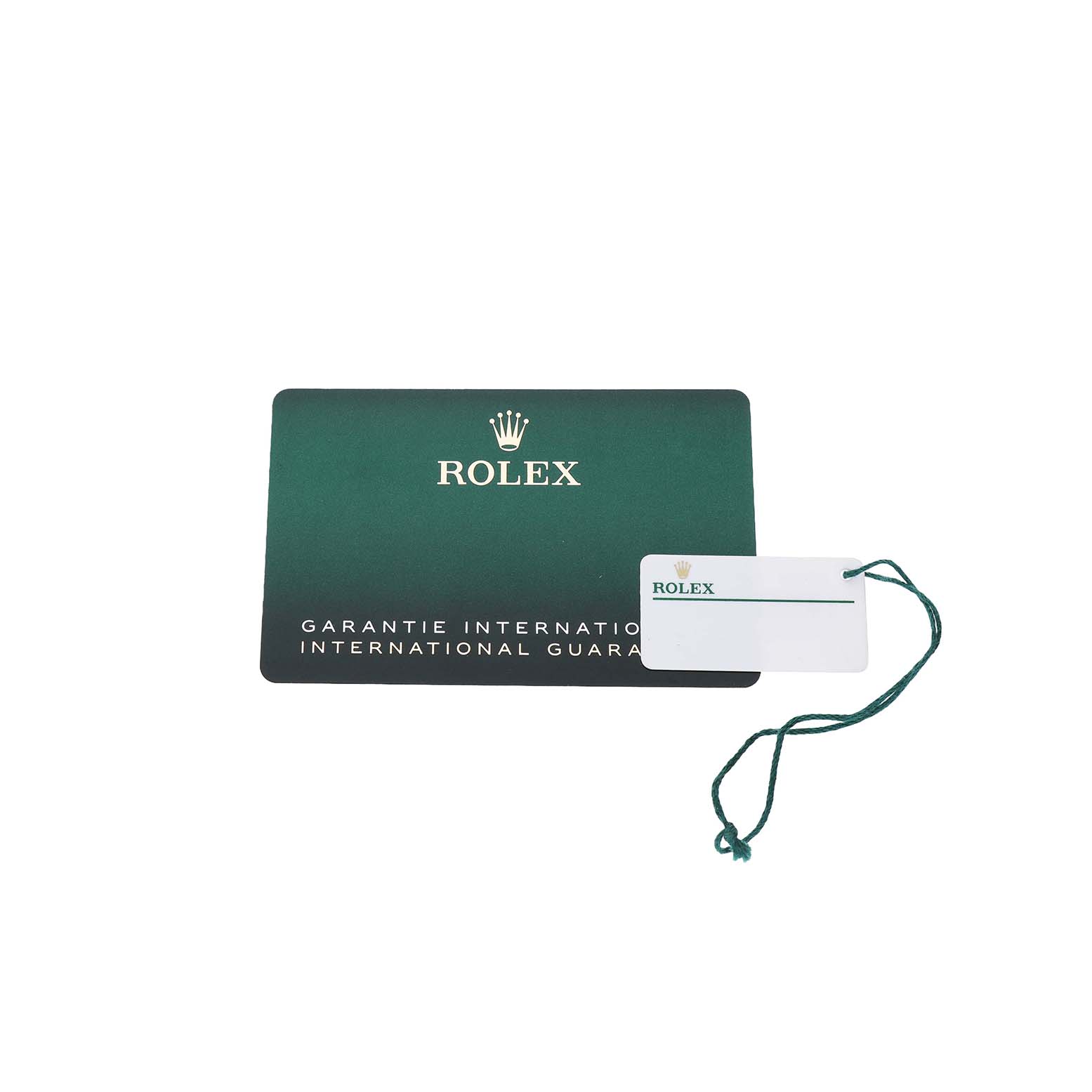 This image shows the international guarantee card and tag for a Rolex Mid-Size 278271 Women's Rose Gold White Dial watch, viewed from above.