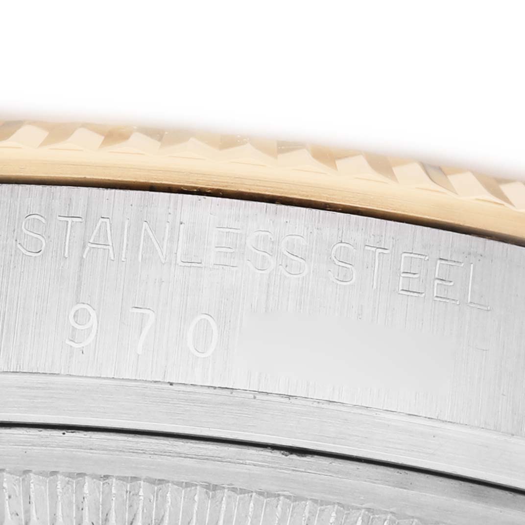 The image shows a close-up of the side of a Rolex Vintage Collection 16013 Men's Steel and Gold (two tone) Champagne Dial watch, highlighting the "Stainless Steel" engraving.