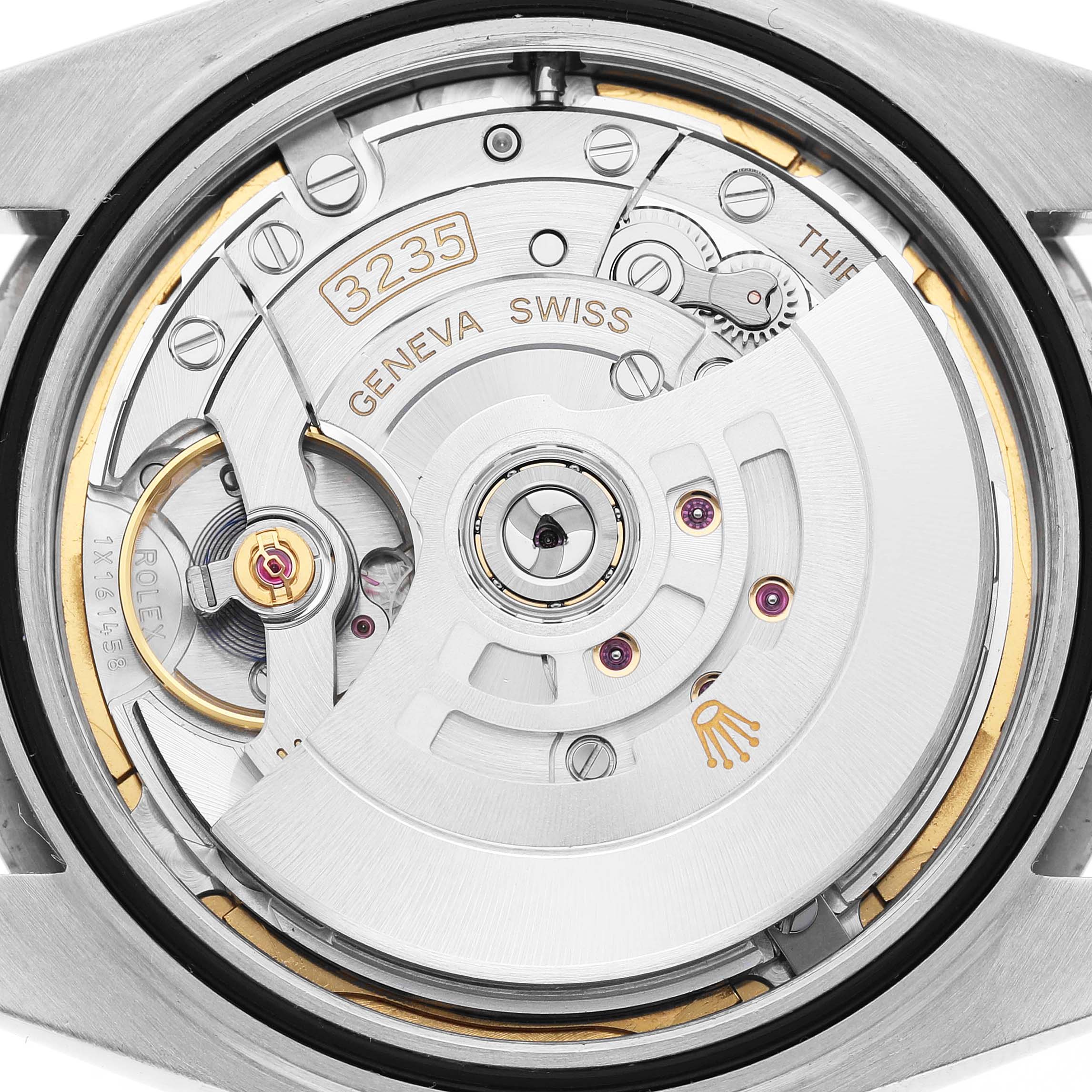 The image shows the movement of a Rolex Datejust 41 126334 Men's White Gold Black Dial, focusing on the rotor, gears, and inscriptions.