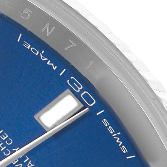 The image shows a close-up of the blue dial and edge details of a Rolex Datejust 41 126334 Men's White Gold Black Dial, including part of an index and "SWISS MADE."
