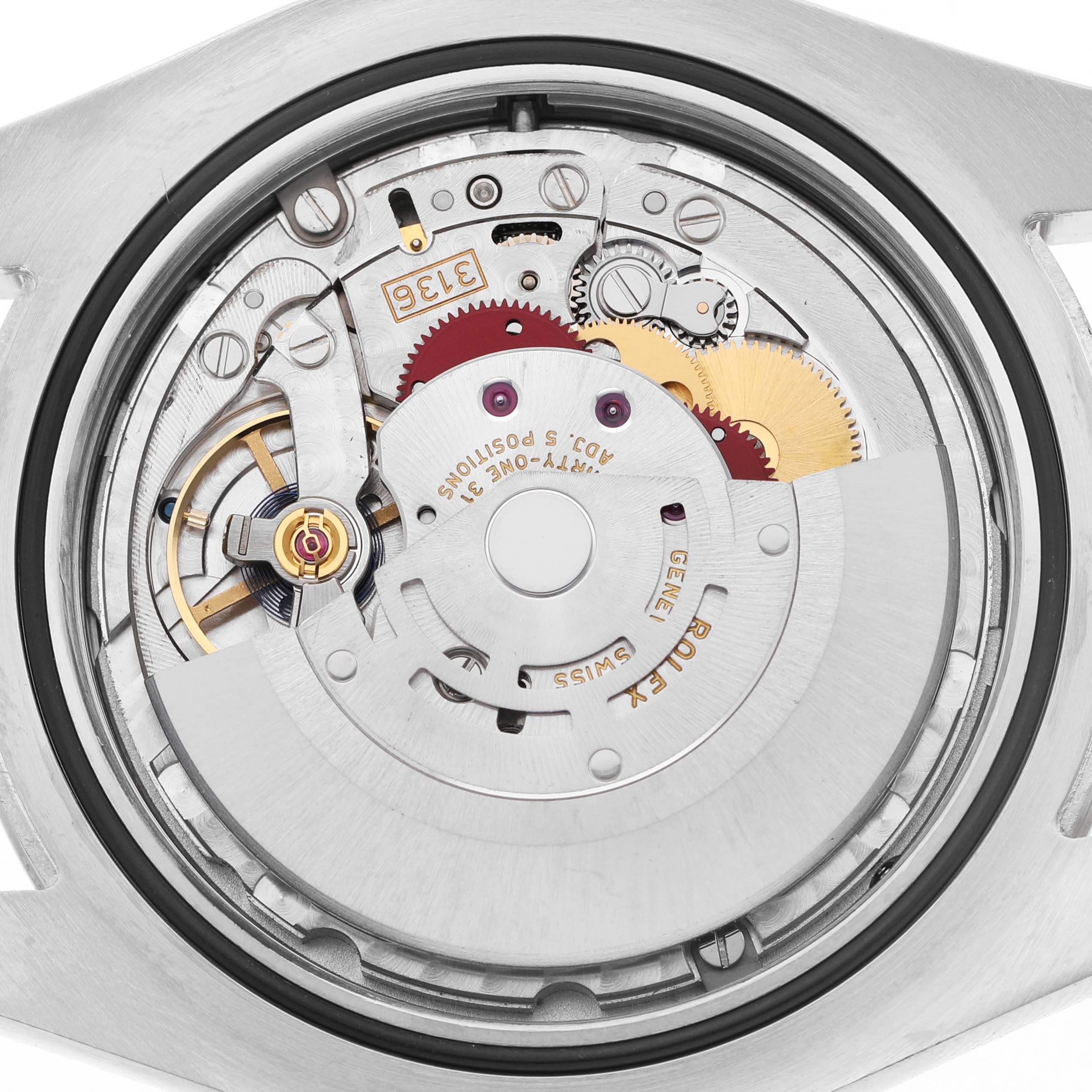 The image shows the movement of the Rolex Datejust 41 116334 Men's Stainless Steel Blue Dial, featuring gears and rotor from a top-down angle.