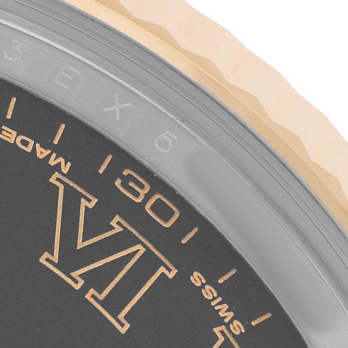 The image shows a close-up of the dial and fluted bezel of a Rolex Datejust 41 116333 Men's Steel and Gold (two tone) Black Dial watch, emphasizing the minute markers and Roman numerals.