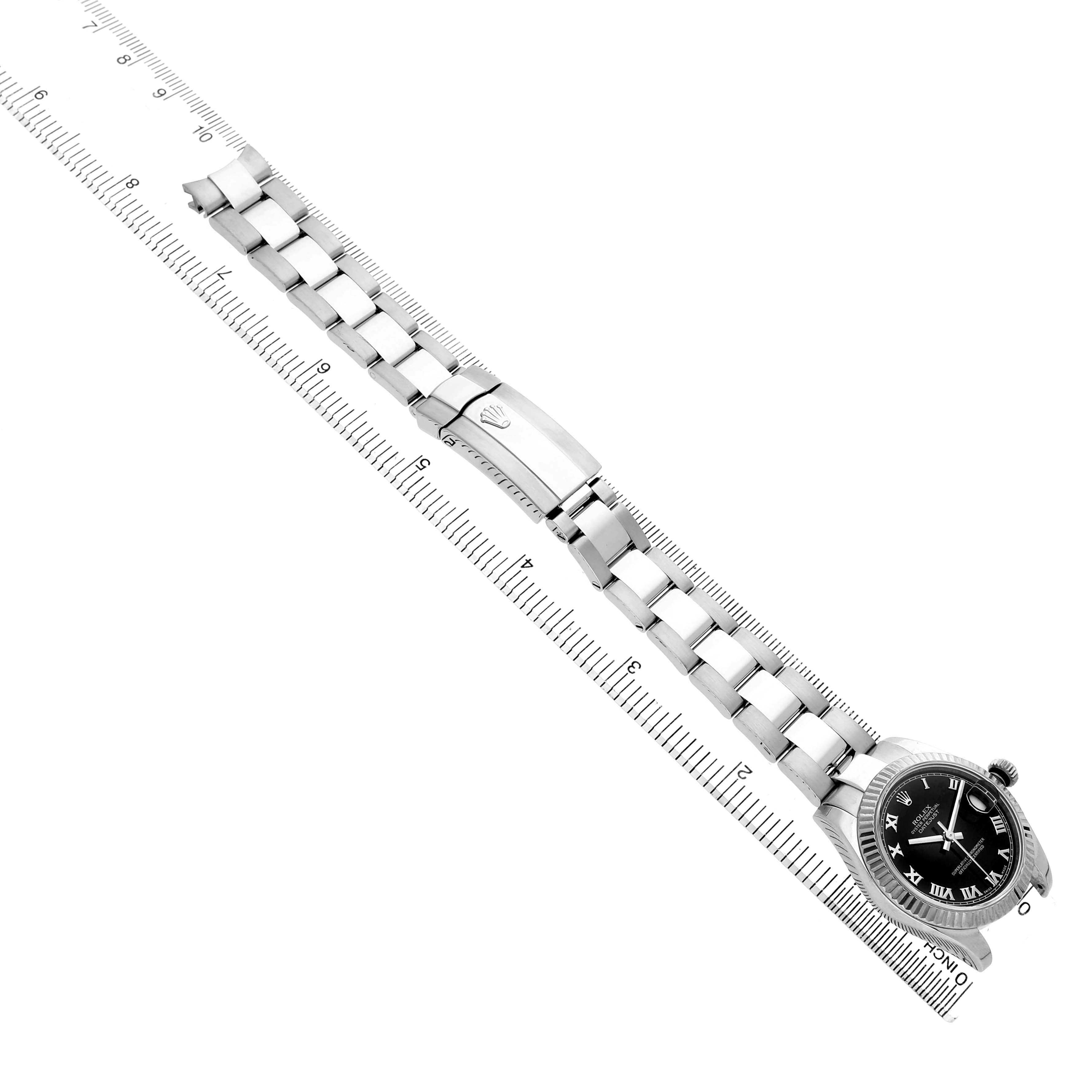 The image shows a Rolex Mid-Size 178274 Women's Stainless Steel Black Dial watch from a top-down angle, highlighting the bracelet, clasp, and black dial.