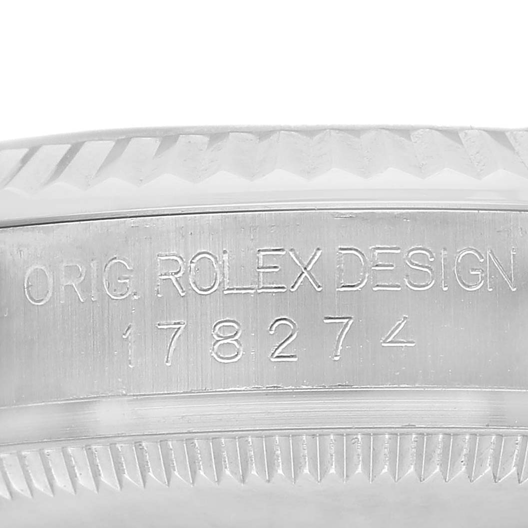 The image shows a close-up of the side of a Rolex Mid-Size 178274 Women's Stainless Steel Black Dial watch, featuring the model number 178274 and engraved details.