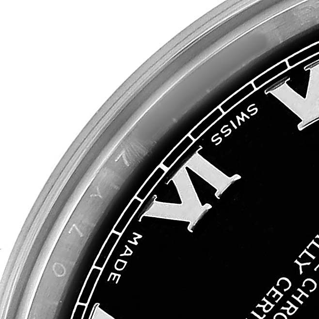 The image shows a close-up of the top part of a Rolex Mid-Size 178274 Women's Stainless Steel Black Dial watch, featuring part of the bezel and Roman numerals.