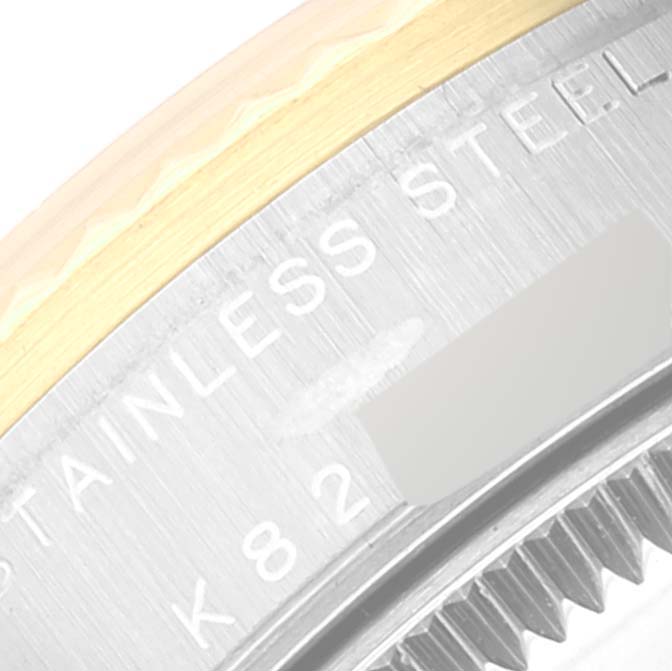 This close-up angle shows the side view of the bezel and casing of the Rolex Mid-Size 78273 Women
s Steel and Gold (two tone) Champagne Dial 78273 Women
s Steel and Gold (two tone) Champagne Dial watch, highlighting the "STAINLESS STEEL" marking.