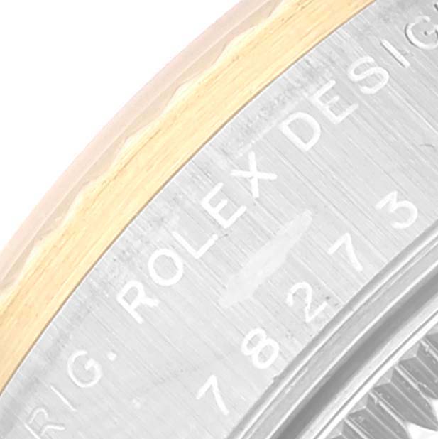 This close-up at an angle shows the side engraving and the edge of the bezel of a Rolex Mid-Size 78273 Women
s Steel and Gold (two tone) Champagne Dial 78273 Women
s Steel and Gold (two tone) Champagne Dial model.