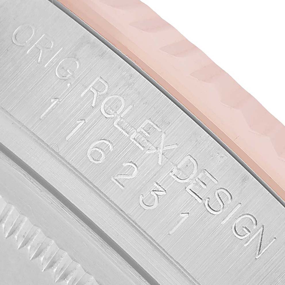 The image shows a close-up of the engraved side, including the bezel and casing, of a Rolex Datejust 116231 Men's Steel and Gold (two tone) Pink Dial watch.
