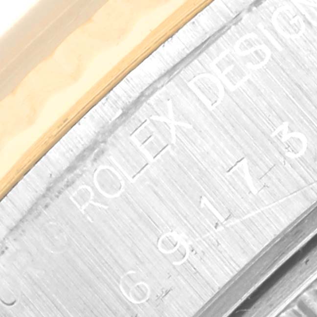 The image shows a close-up of the side of a Rolex Datejust 69173 Women's Steel and Gold (two tone) Black Dial 69173 Women's Steel and Gold (two tone) Black Dial watch, revealing the engraved "ROLEX DESIGN" text.
