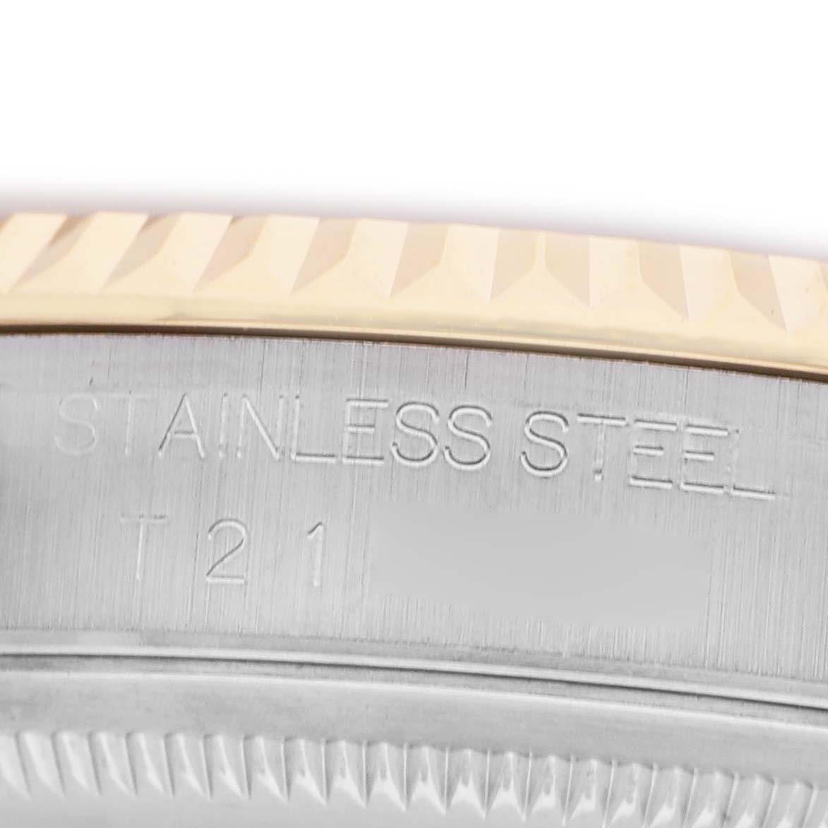 The image shows a close-up view of the side, focusing on the engraved "STAINLESS STEEL" on a Rolex Datejust 16233 Men's Stainless Steel Champagne Dial watch's bezel.