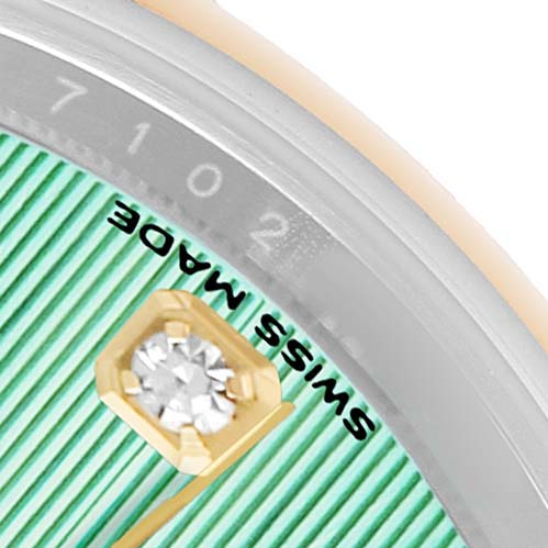 This close-up image of the Rolex Datejust 279163 Women's Steel and Gold (two tone) Green Dial shows part of the dial, a diamond hour marker, and the "SWISS MADE" text.