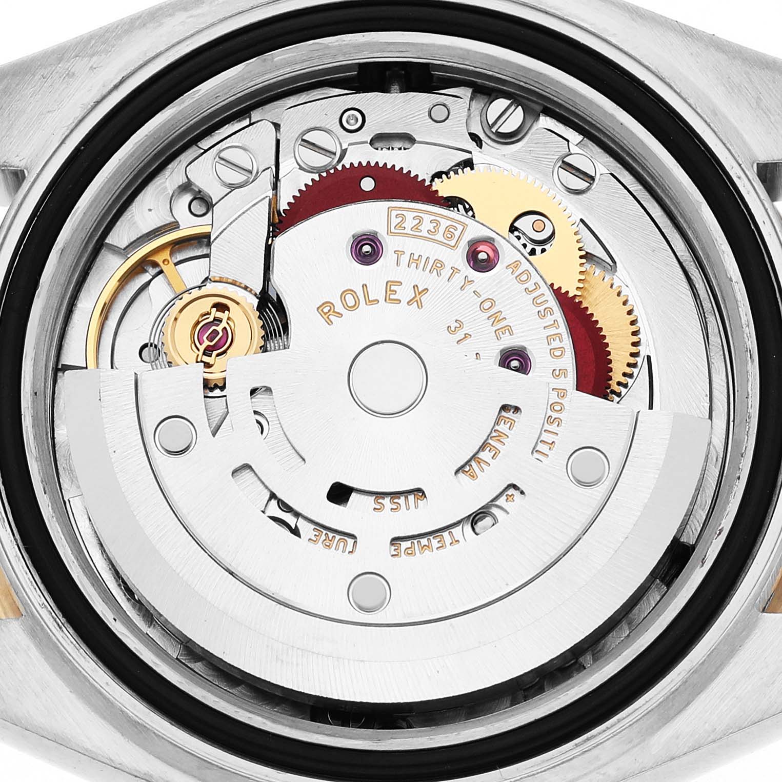 The image shows a close-up of the movement inside a Rolex Datejust 279163 Women's Steel and Gold (two tone) Green Dial, highlighting gears and the rotor mechanism.