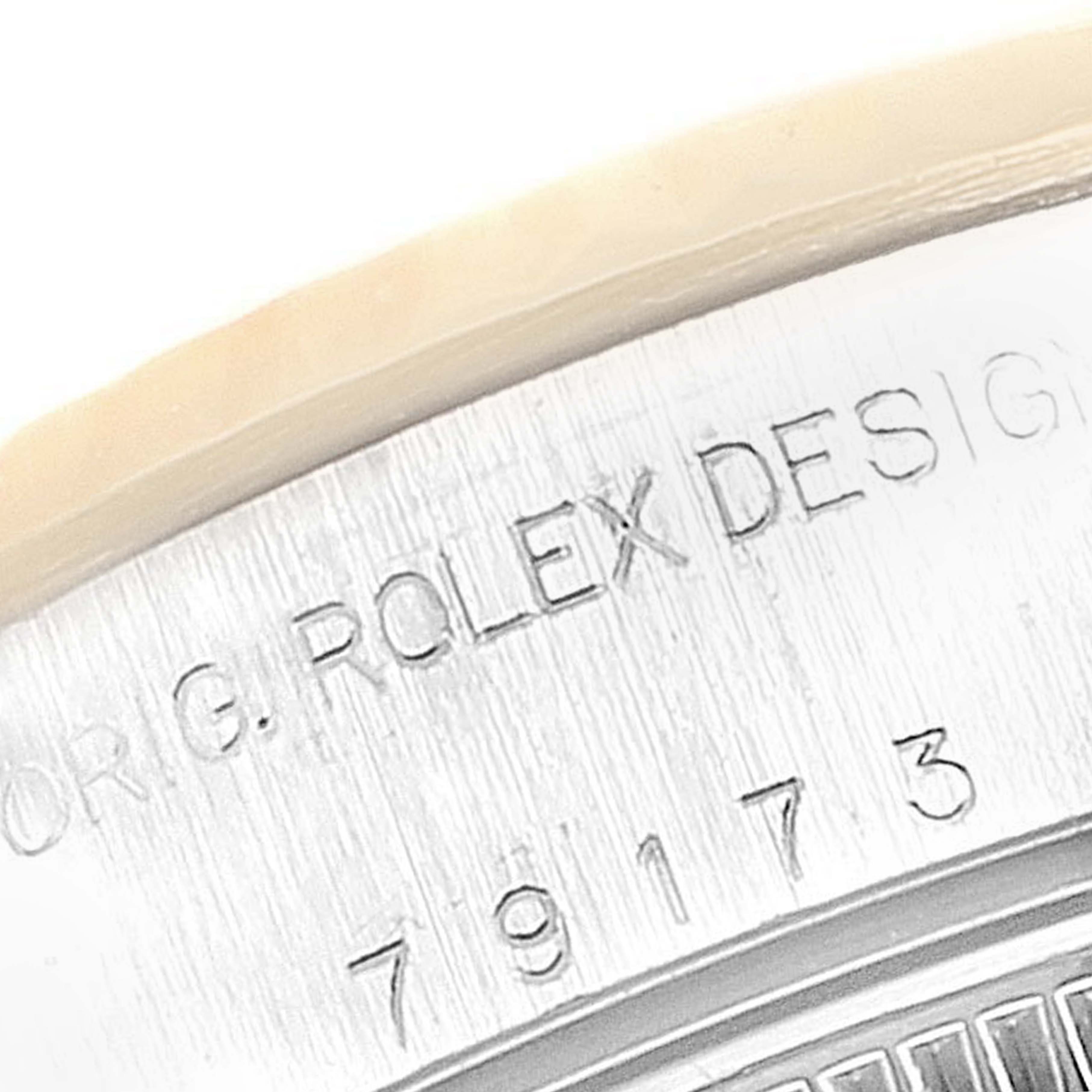 This close-up image shows the engraved side details of a Rolex Datejust 79173 Women
s Steel and Gold (two tone) Silver Dial 79173 Women
s Steel and Gold (two tone) Silver Dial watch case.