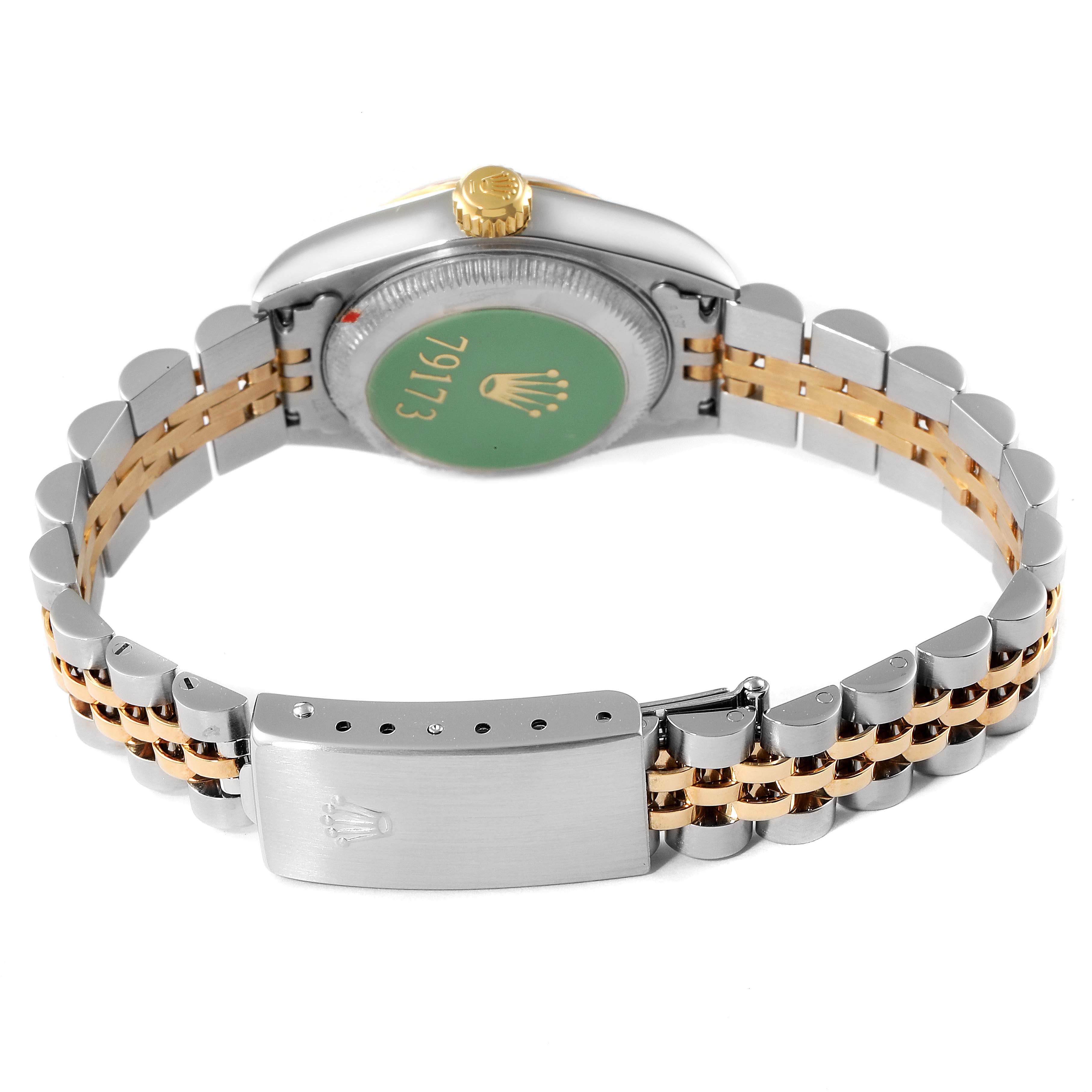 This angle shows the back of a Rolex Datejust 79173 Women
s Steel and Gold (two tone) Silver Dial 79173 Women
s Steel and Gold (two tone) Silver Dial watch with its clasp and two-tone bracelet.