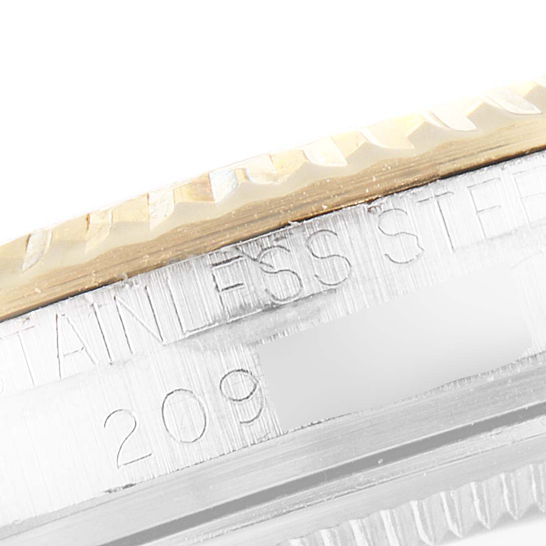 The image shows a close-up of the bezel and part of the case of the Rolex Vintage Collection 1601 Men's Steel and Gold (two tone) Silver Dial 1601 Men's Steel and Gold (two tone) Silver Dial model, highlighting its "stainless steel" engraving.